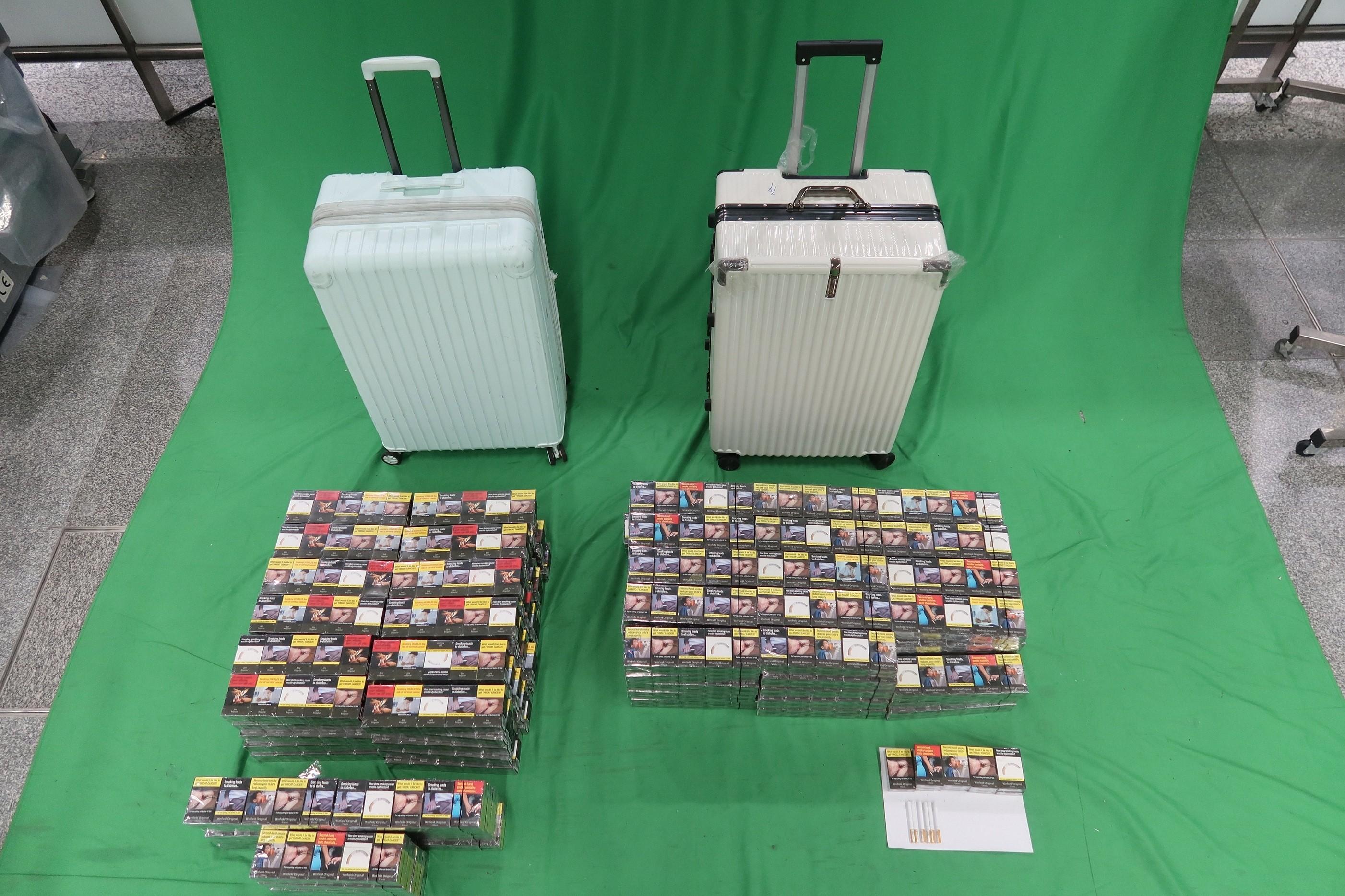 Three incoming passengers were sentenced to between three to six months' imprisonment and fined $1,000 by the West Kowloon Magistrates' Courts yesterday (May 4) and today (May 5) for importing duty-not-paid cigarettes and failing to declare them to Customs officers, as well as for importing alternative smoking products, in contravention of the Dutiable Commodities Ordinance and the Import and Export Ordinance. Photo shows the duty-not-paid cigarettes seized from the personal baggage of the 24-year-old incoming male passenger.