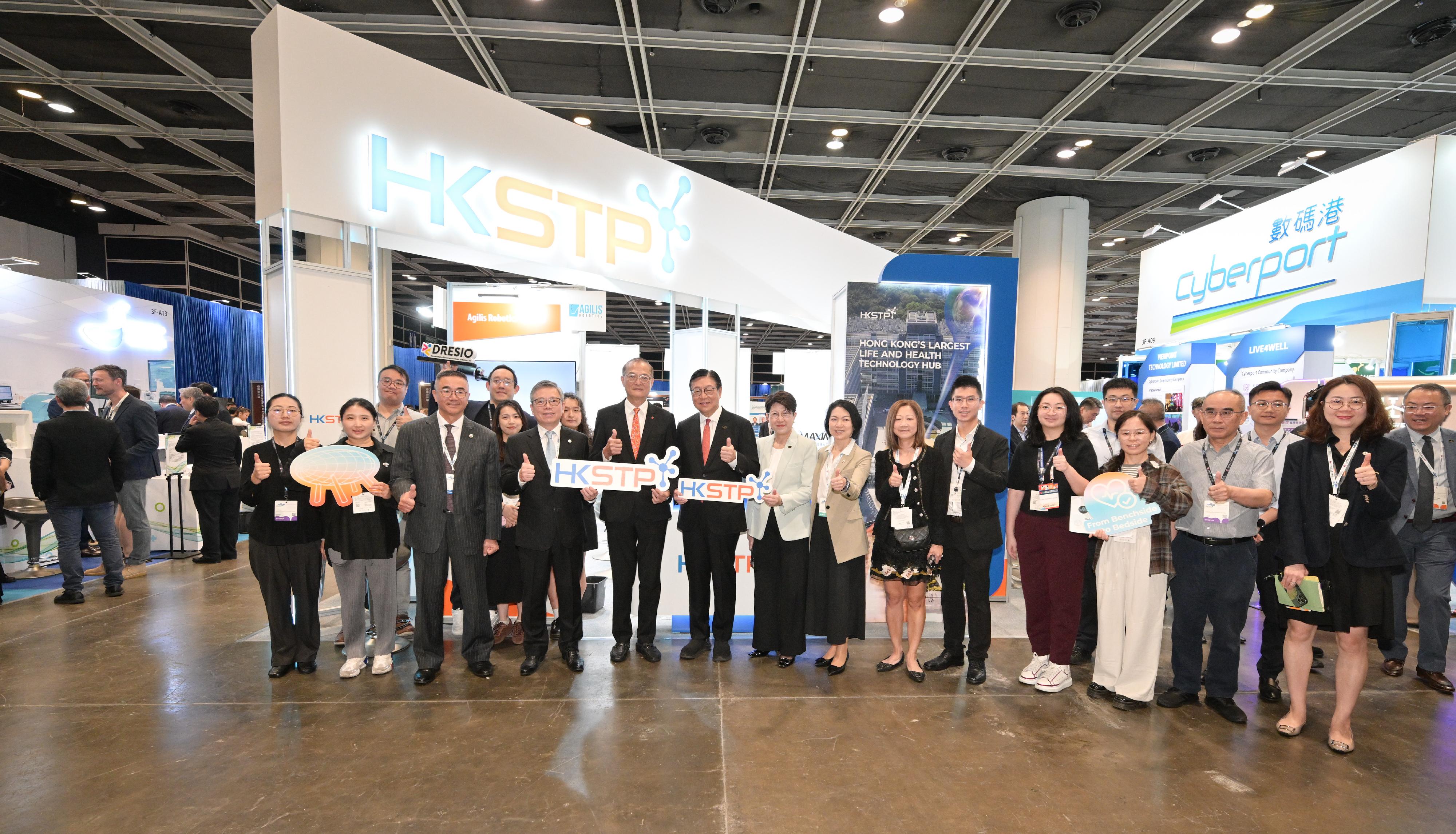 The Secretary for Health, Professor Lo Chung-mau (front row, fifth left), tours an exhibition booth set up at the Asia Summit on Global Health today (May 11).