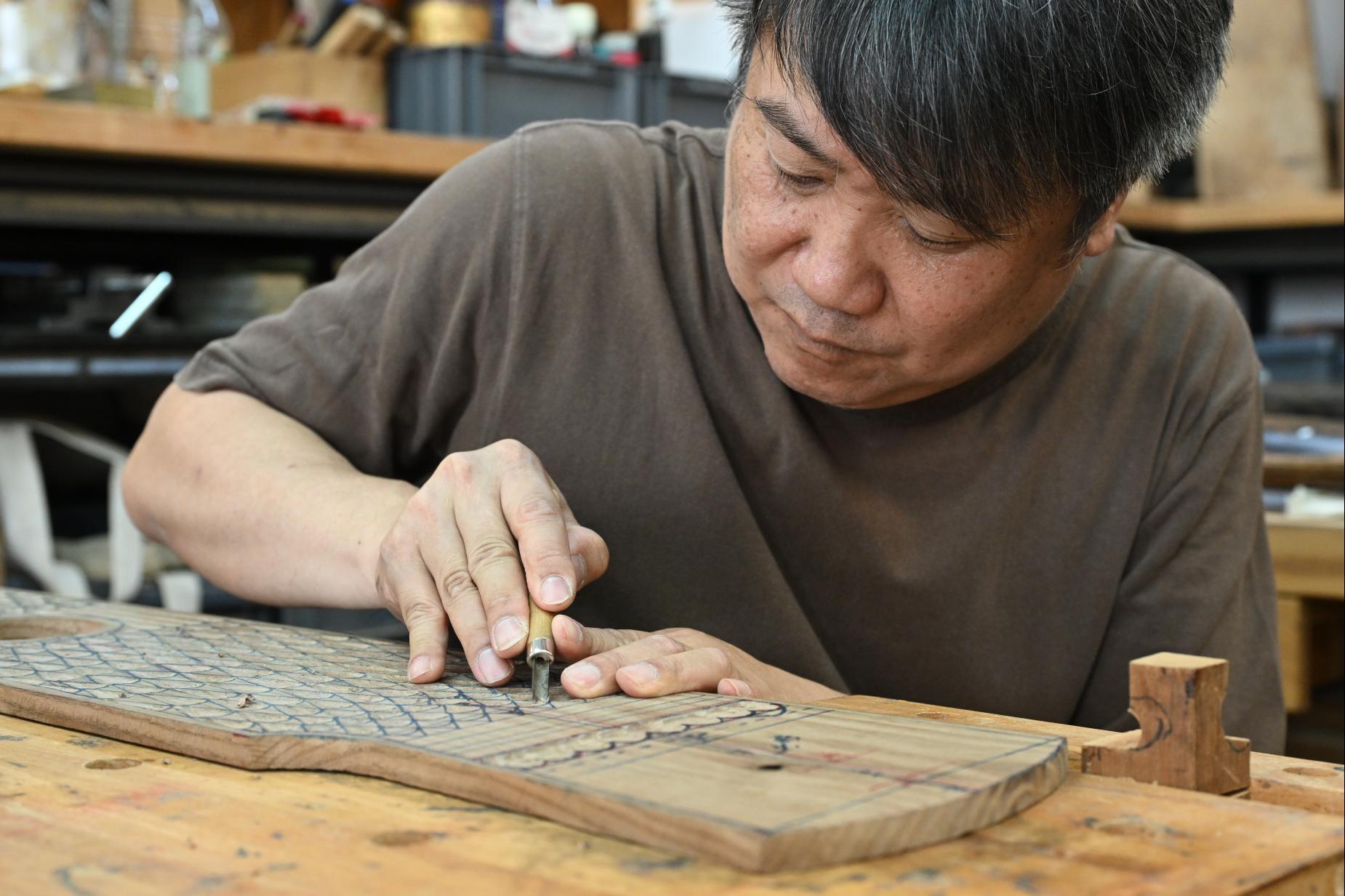 The Intangible Cultural Heritage Office of the Leisure and Cultural Services Department will organise the Hong Kong ICH Month 2026 in June. Registration for the public tours under the highlight programme, "The Hong Kong Jockey Club Series: ICH Highlight Tours", in eight handpicked districts featuring nine routes, will open on May 15 and 16. Photo shows the Arts of the Guqin (the Craft of Qin Making), one of the ICH items in the route in Sham Shui Po District. Qin making is an exquisite craft that starts with chopping and trimming a piece of wood, and involves nine exquisite steps, namely seeking, shaping, hollowing, inlaying, assembling, priming, polishing, lacquering and stringing, until it reaches the final stage of becoming an instrument.
