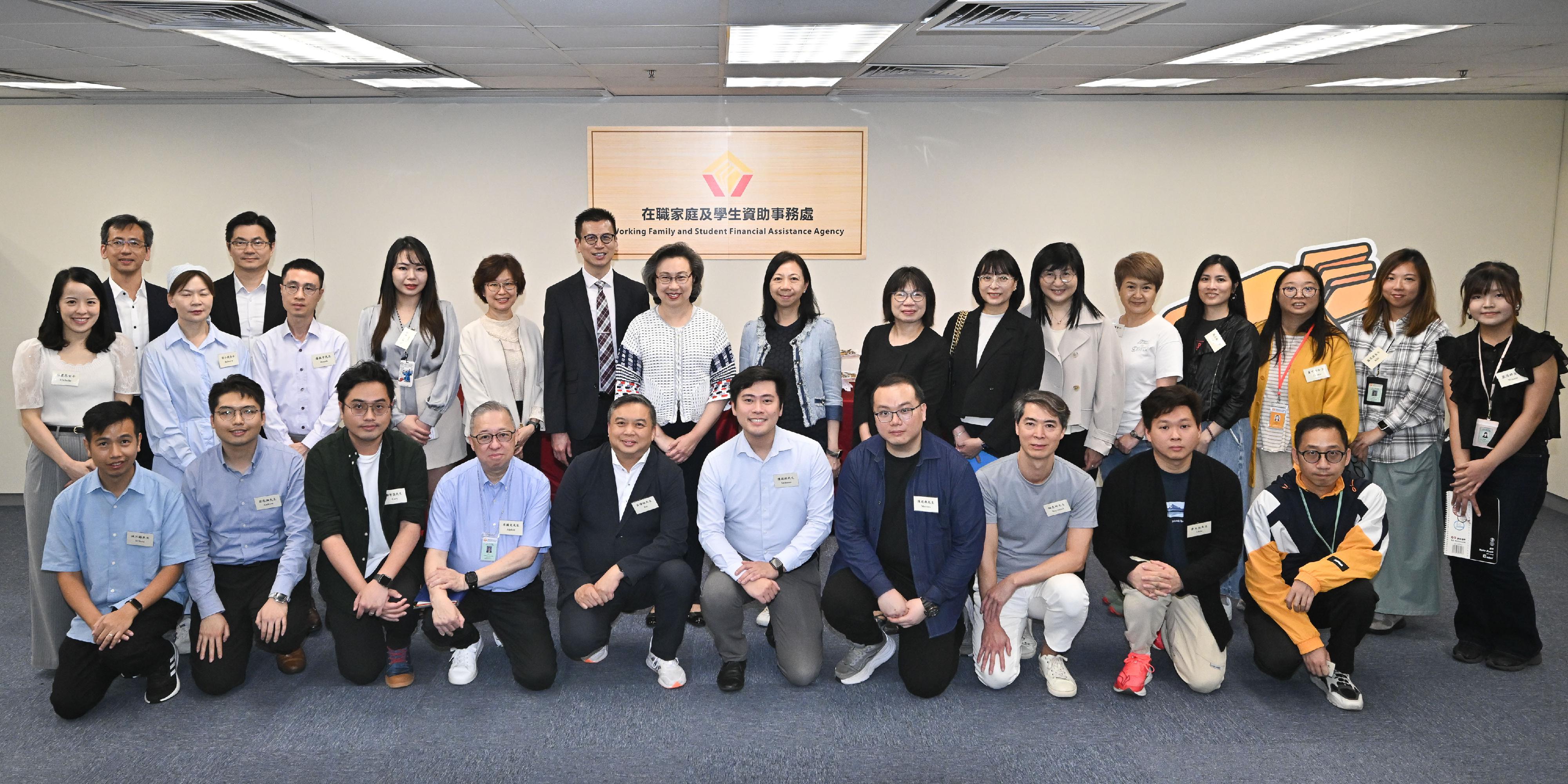 The Secretary for the Civil Service, Mrs Ingrid Yeung, visited the Working Family and Student Financial Assistance Agency (WFSFAA) this afternoon (May 15) to learn about the department's recent efforts in applying technology and enhancing service quality and efficiency. Photo shows Mrs Yeung (second row, seventh left); the Permanent Secretary for the Civil Service, Ms Shirley Lam (second row, eighth left); and the Head, WFSFAA, Mr Gilford Law (second row, sixth left), with staff representatives from various grades in the department.
