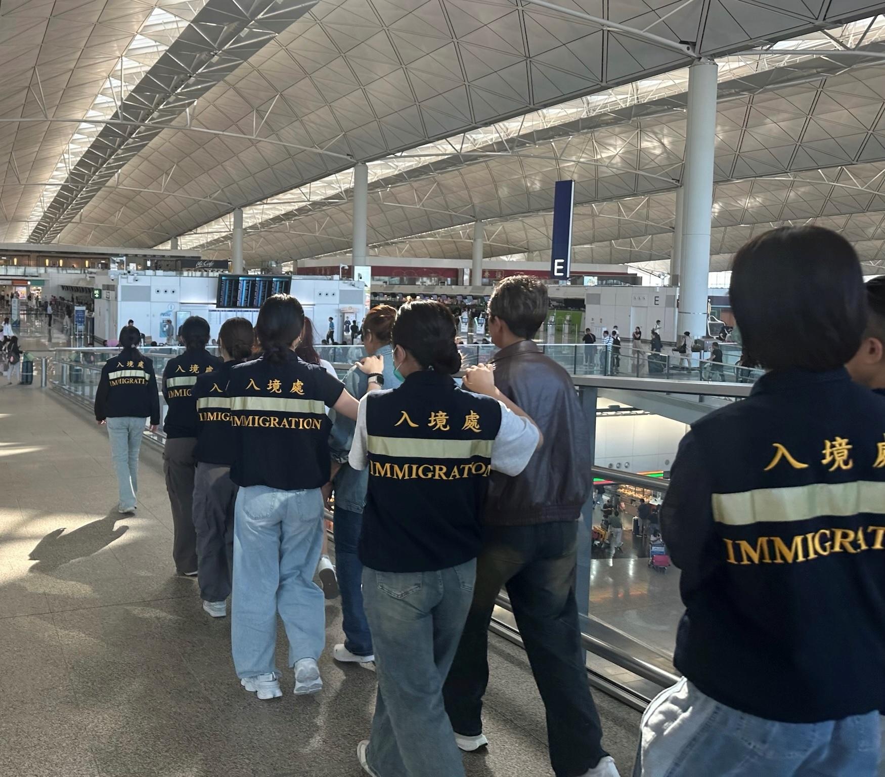 The Immigration Department (ImmD) carried out repatriation operations from May 13 to today (May 15). A total of 35 unsubstantiated non-refoulement claimants were repatriated to their places of origin. Photo shows removees being escorted by ImmD officers to depart from Hong Kong.