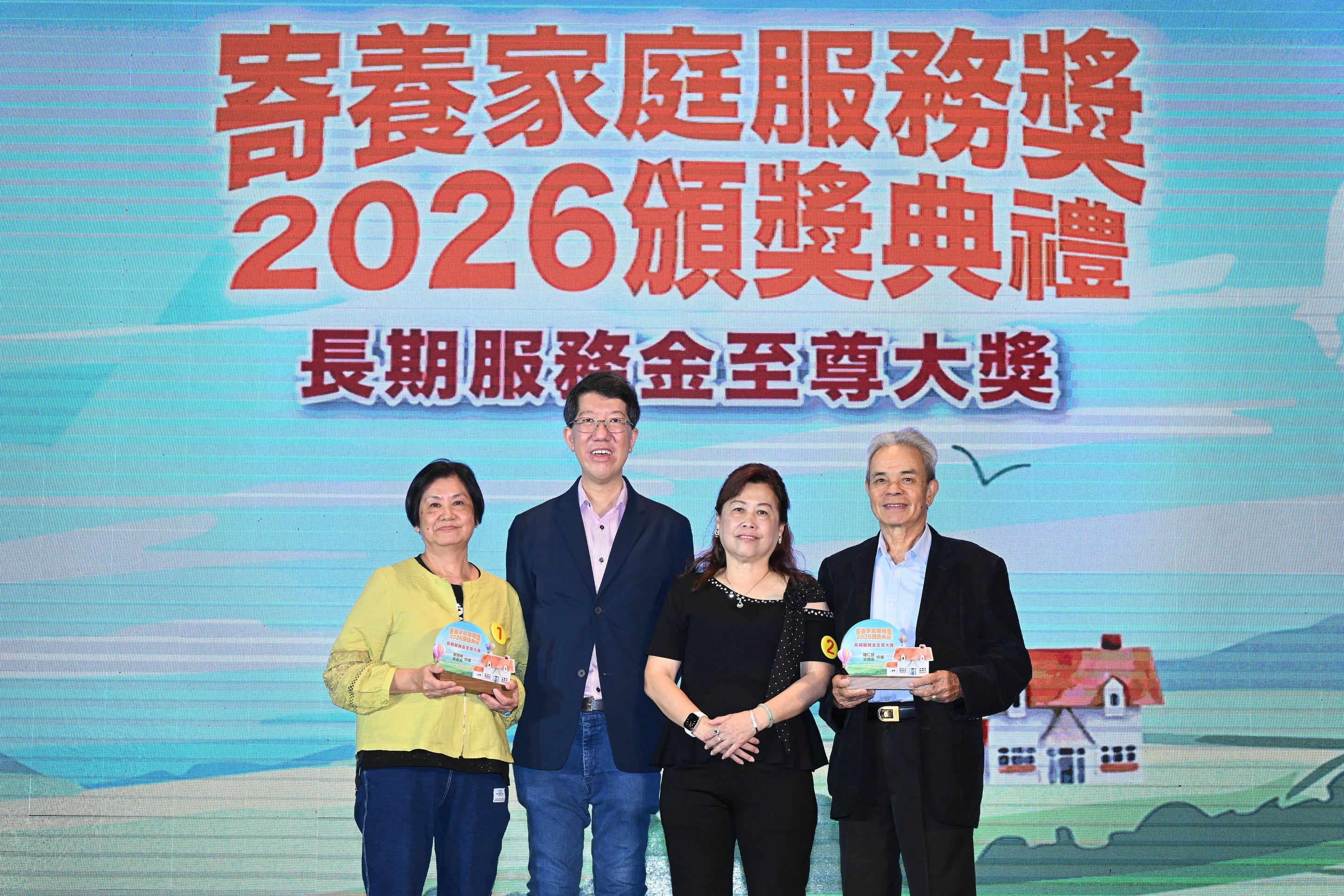 社會福利署(社署)署長杜永恒(左二)今日(五月十七日)在社署舉辦的「2026寄養家庭服務獎頒獎典禮」向服務超過30年的寄養家庭頒發「長期服務金至尊大獎」。