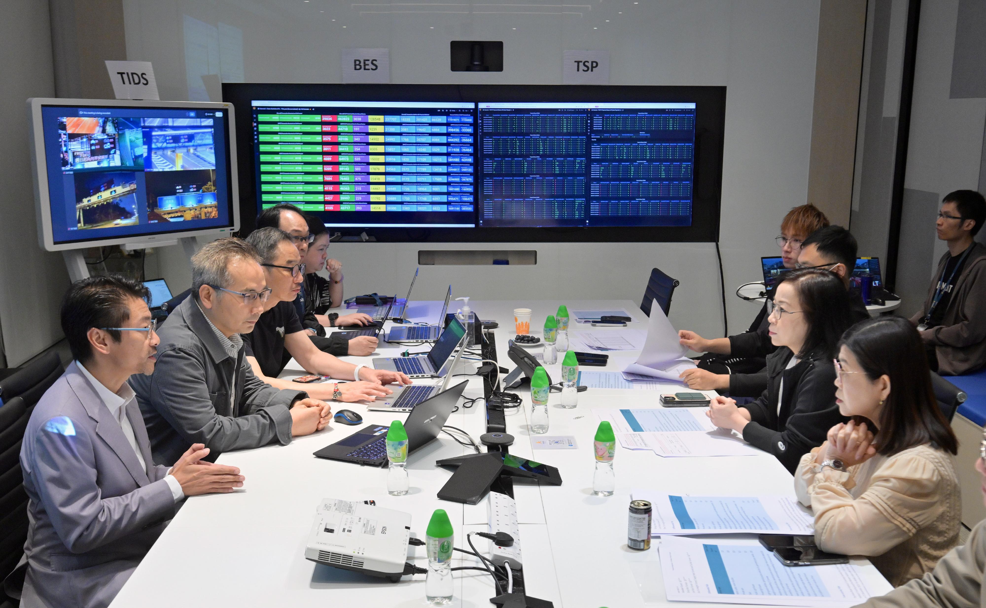 The Government has waived 50 per cent of the toll for commercial vehicles using government tolled tunnels and the Tsing Sha Control Area from 0.00am today (May 17). The system operations have mostly been smooth, while overall traffic conditions have remained generally normal. Photo shows the Commissioner for Transport, Miss Winnie Tse (second right), accompanied by the Assistant Commissioner for Transport/Management and Paratransit, Ms Louisa Fung (first right), being briefed by the toll service provider on the adjustments to the system and toll information displays during her visit to the HKeToll control centre in the early hours today.