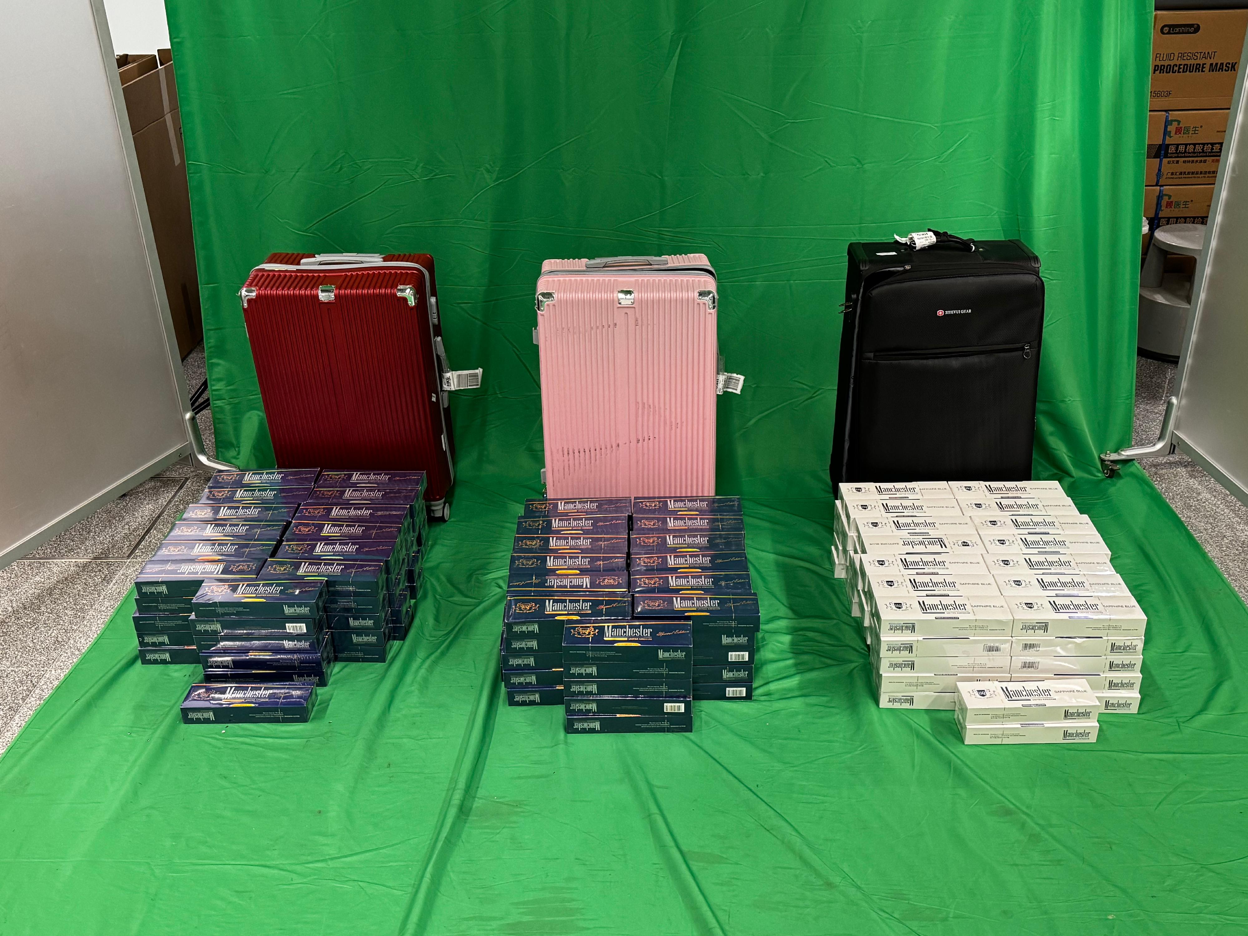 Three incoming passengers were sentenced to two to six months' imprisonment and fined $1,000 respectively by the West Kowloon Magistrates' Courts today (May 18) for importing duty-not-paid cigarettes and failing to declare them to Customs officers, in contravention of the Dutiable Commodities Ordinance. Photo shows the duty-not-paid cigarettes seized from the personal baggage of a 27-year-old incoming male passenger.