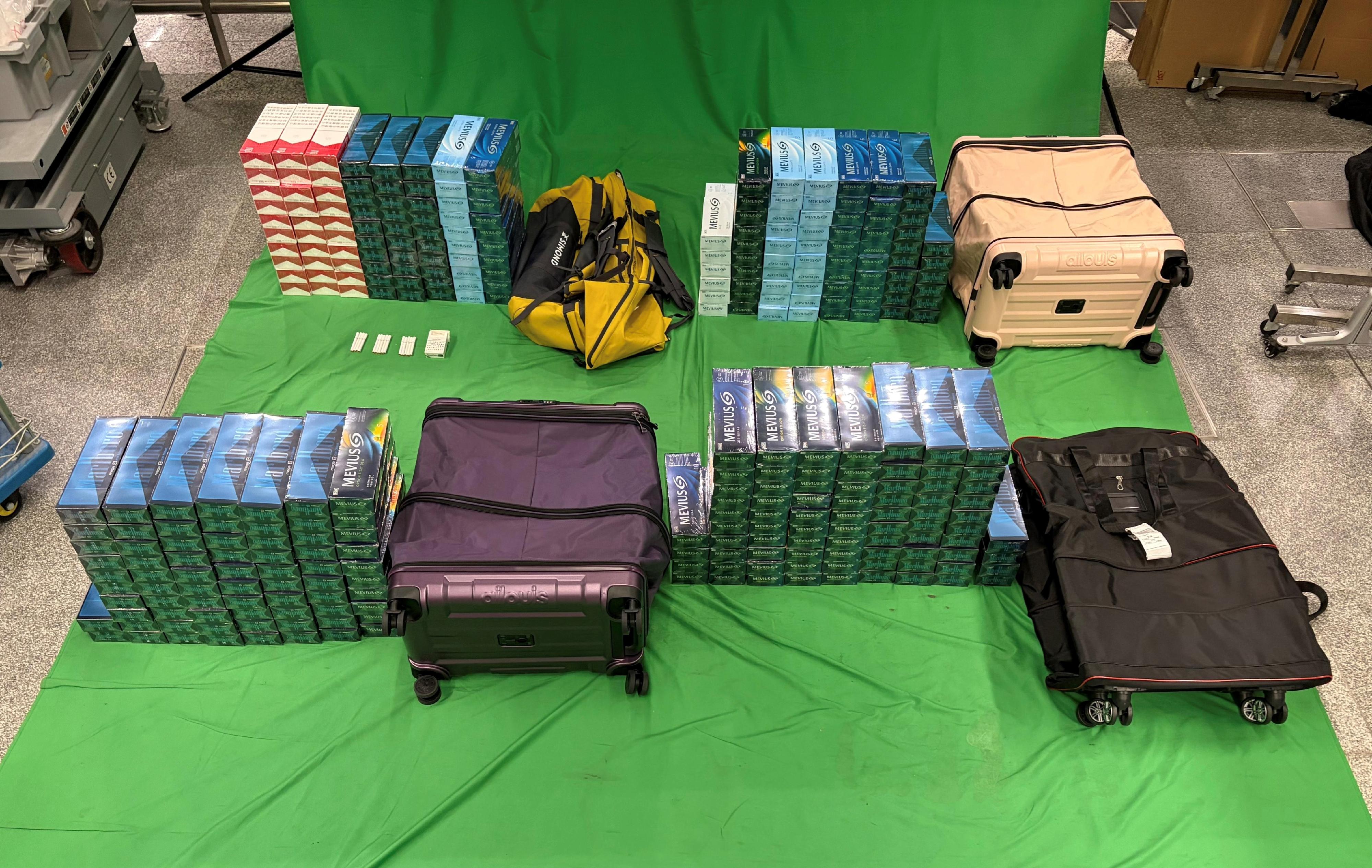Three incoming passengers were sentenced to two to six months' imprisonment and fined $1,000 respectively by the West Kowloon Magistrates' Courts today (May 18) for importing duty-not-paid cigarettes and failing to declare them to Customs officers, in contravention of the Dutiable Commodities Ordinance. Photo shows the duty-not-paid cigarettes seized from the personal baggage of a 39-year-old incoming male passenger.