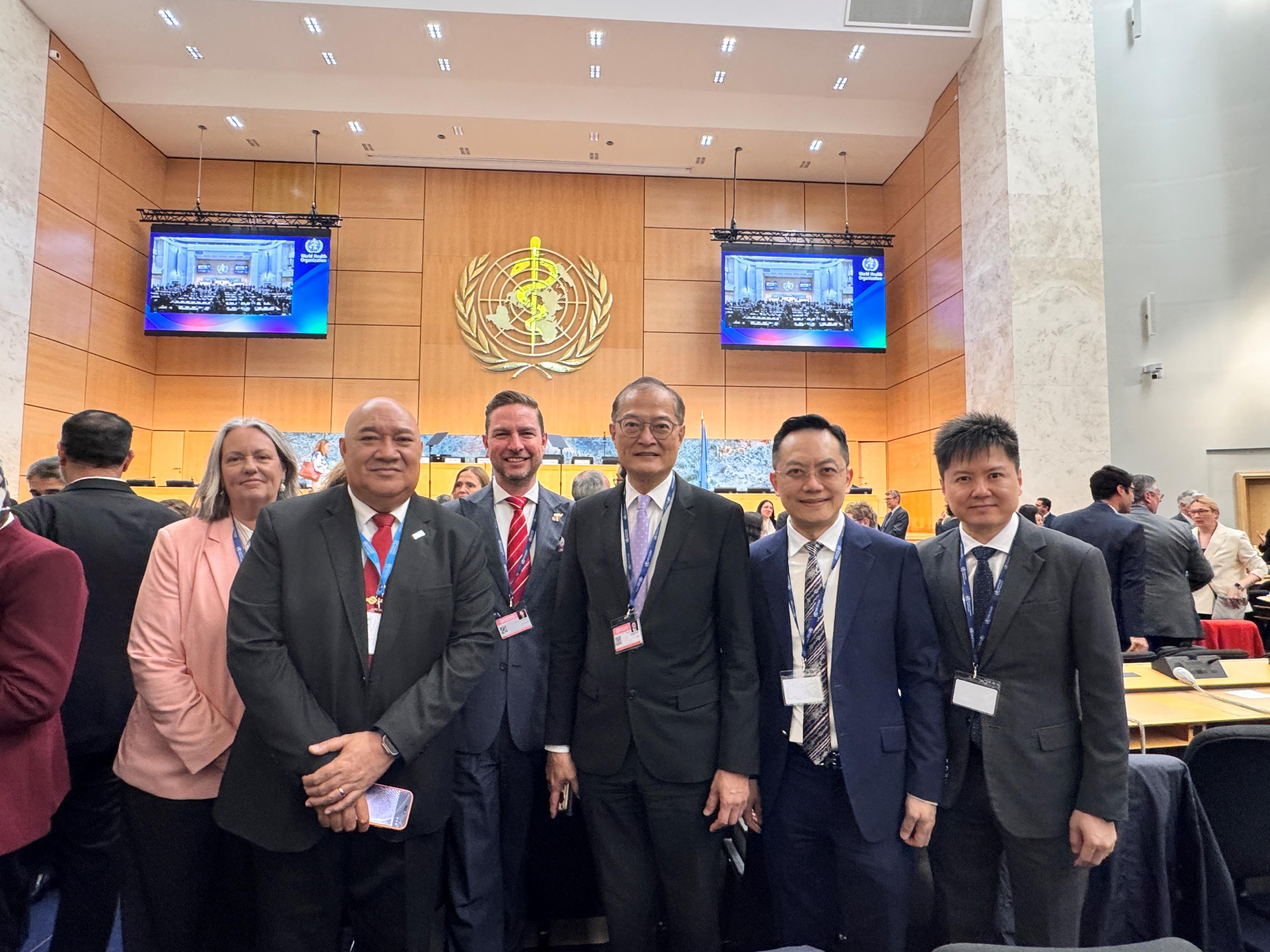 The Secretary for Health, Professor Lo Chung-mau, attended the 79th World Health Assembly of the World Health Organization (WHO) as a member of the Chinese delegation in Geneva, Switzerland, yesterday (May 18, Geneva time). Photo shows Professor Lo (third right); the Director of Health, Dr Ronald Lam (second right); and the Controller of the Centre for Health Protection of the Department of Health, Dr Edwin Tsui (first right), with the WHO Regional Director for the Western Pacific, Dr Saia Ma'u Piukala (second left), and other attendees.