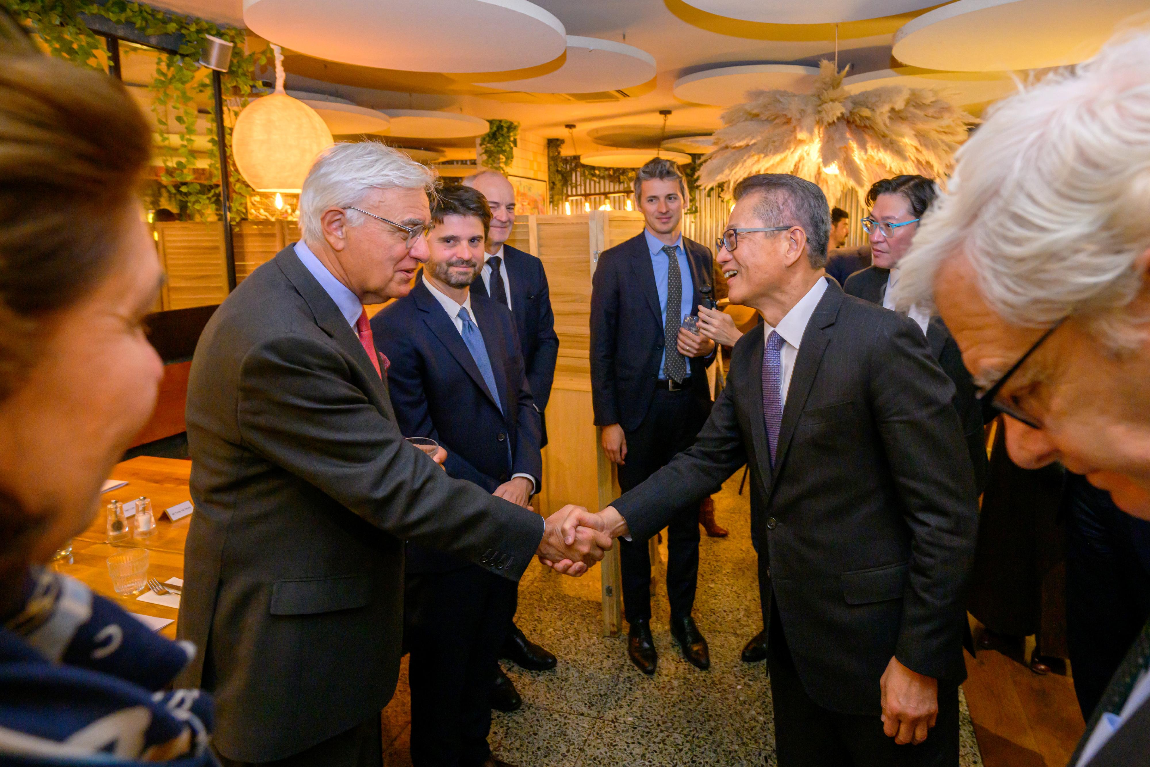 The Financial Secretary, Mr Paul Chan (right), had a meeting with local banking and financial leaders in Paris, France, on May 19 (Paris time) to introduce Hong Kong's latest developments and opportunities as an international financial centre, and exchanged views on the global economic and financial outlook.