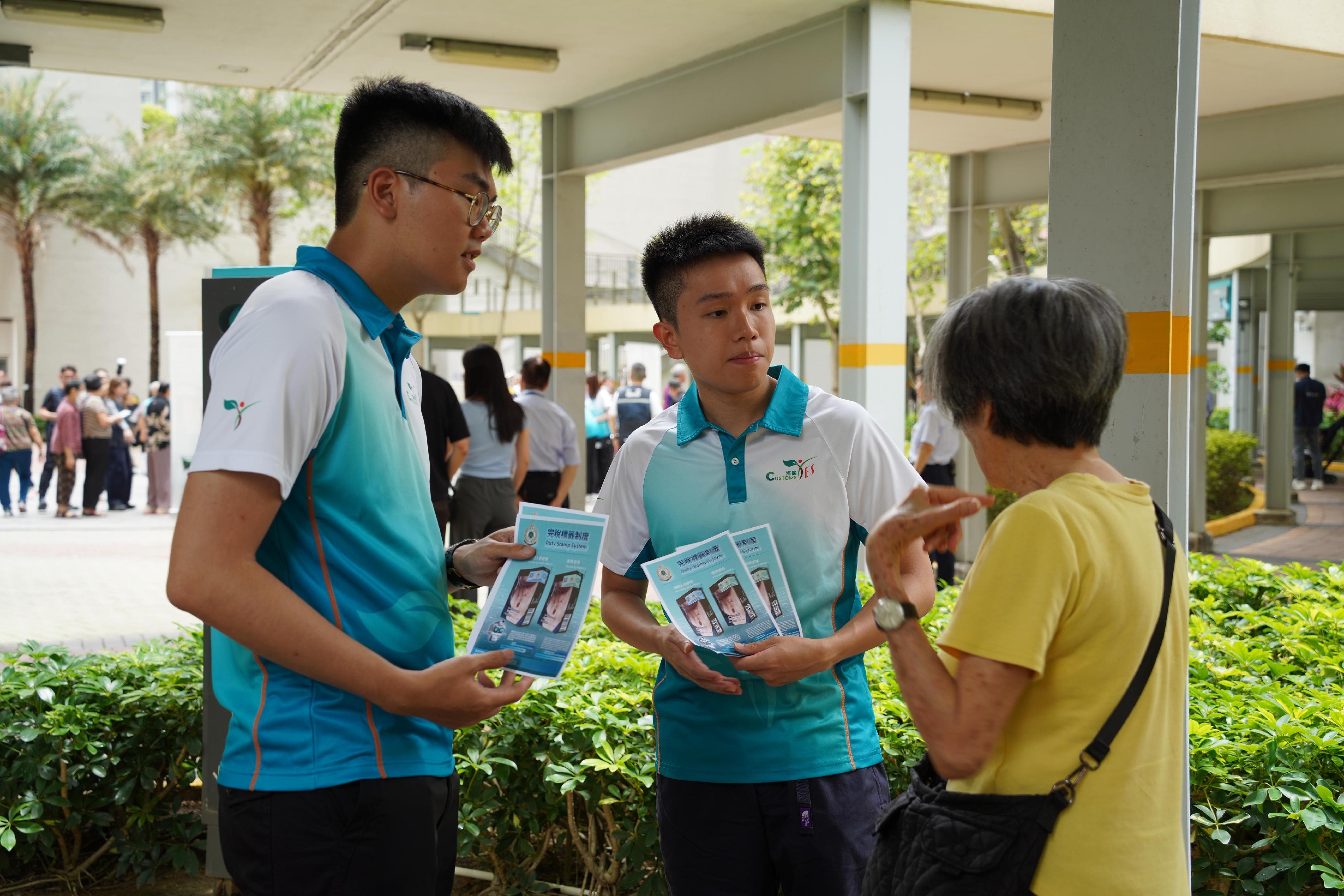 香港海關今日（五月二十日）與區議員、衞生署控煙酒辦公室、警務處及房屋署在啟德德朗邨進行聯合反私煙宣傳活動，並講解完稅標籤制度。「香港海關青年發展計劃」（Customs YES）會員亦有參與是次活動。圖示Customs YES會員向居民宣揚反私煙信息。
