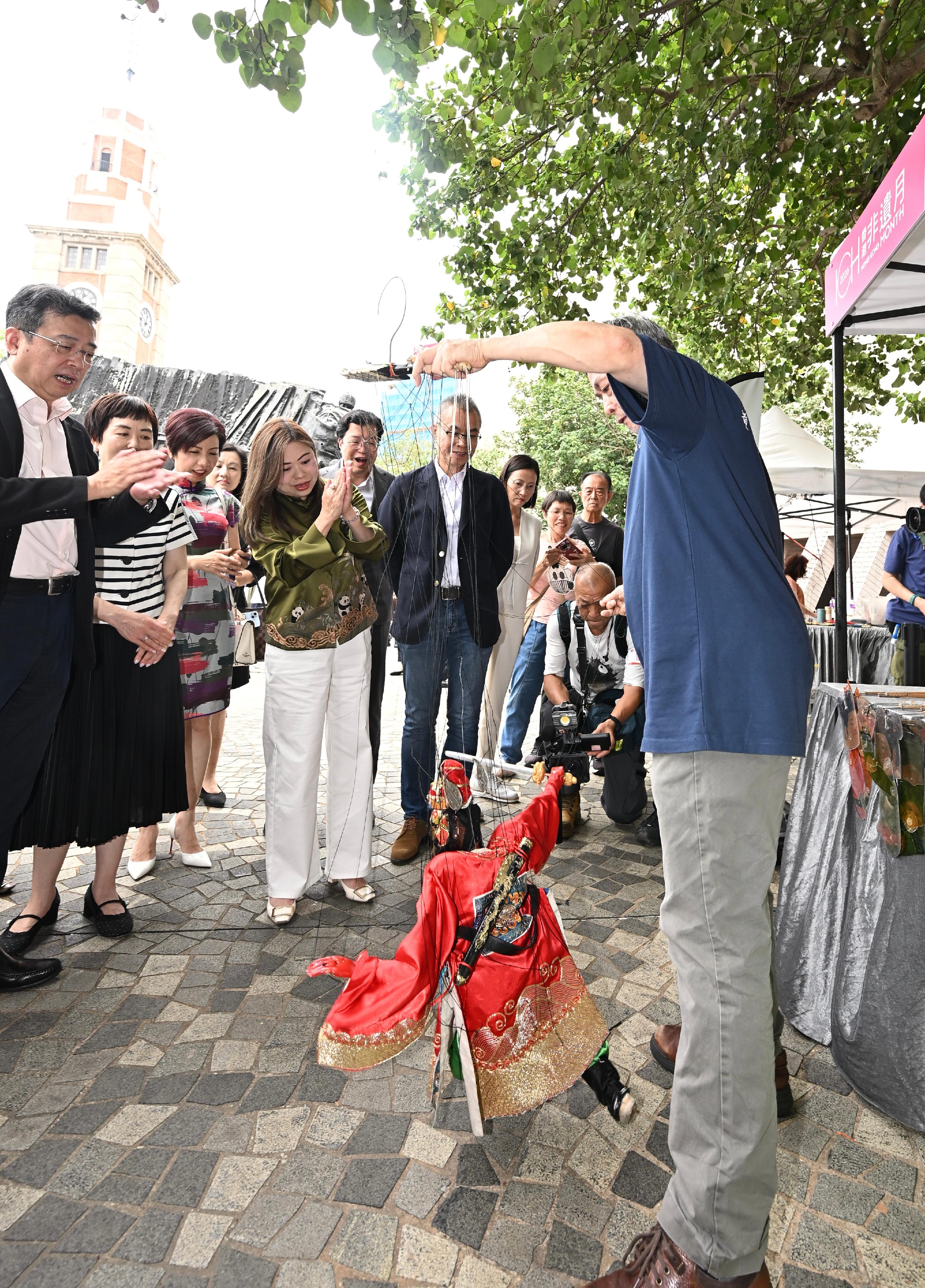 The Hong Kong Jockey Club Series: "Hong Kong ICH Month 2026" Intangible Cultural Heritage Carnival will be held today and tomorrow (May 30 to 31). Photo shows the Secretary for Culture, Sports and Tourism, Miss Rosanna Law (front row, fourth left) and other officiating guests visiting a booth on demonstration and experience on puppetry.
