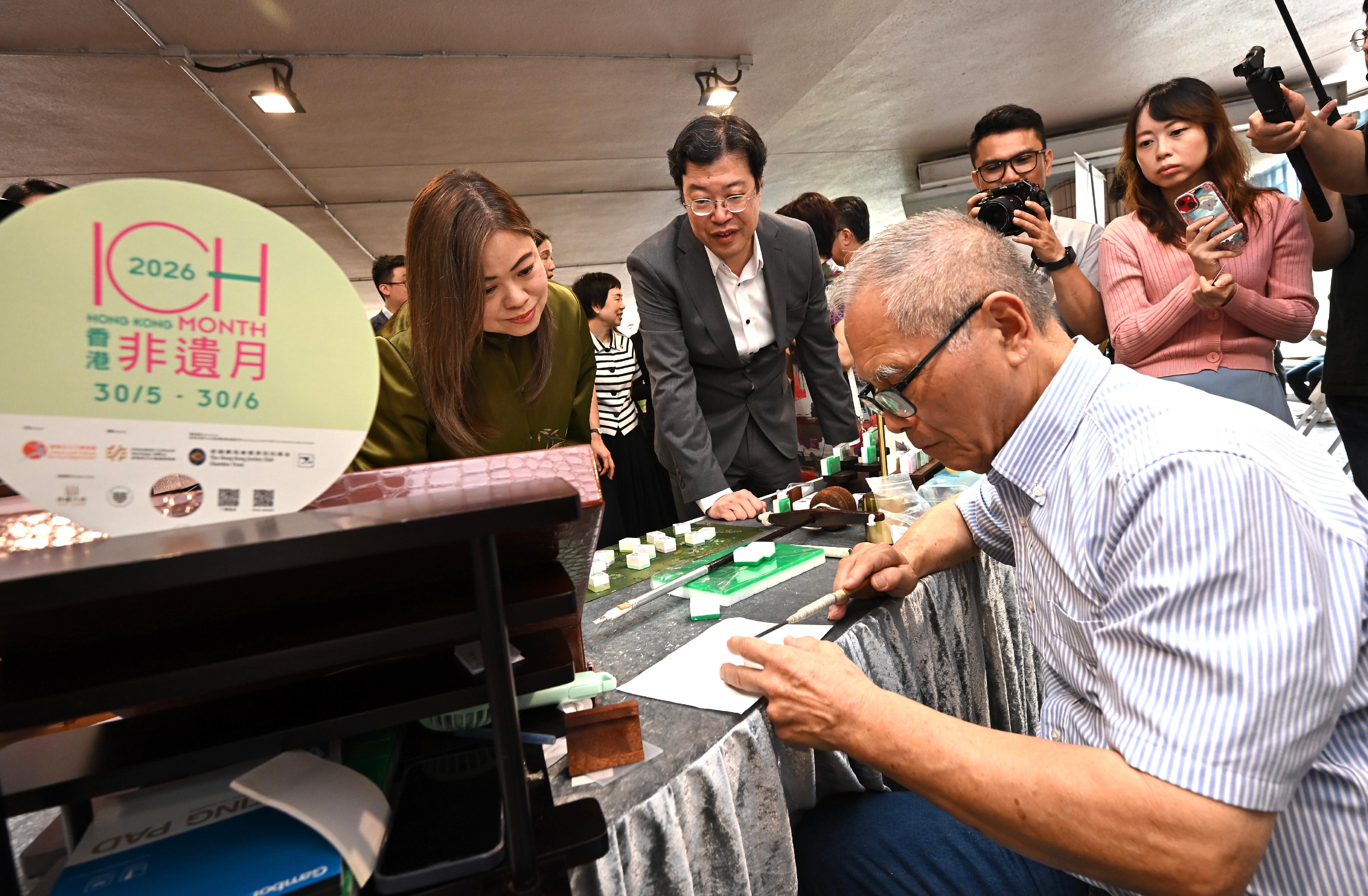 The Hong Kong Jockey Club Series: "Hong Kong ICH Month 2026" Intangible Cultural Heritage Carnival will be held today and tomorrow (May 30 to 31). Photo shows the Secretary for Culture, Sports and Tourism, Miss Rosanna Law (first left) visiting a booth on Mahjong tile making technique.