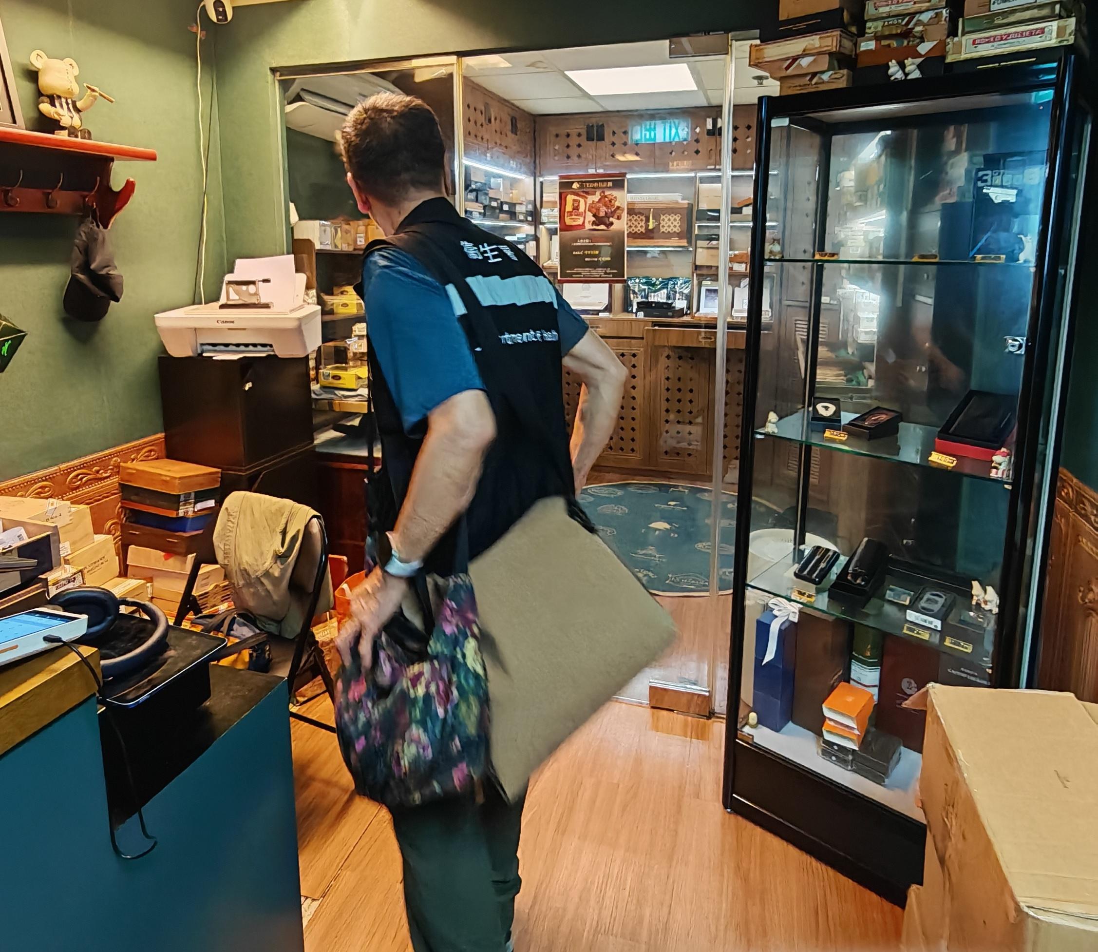 The Tobacco and Alcohol Control Office (TACO) of the Department of Health carried out surprise inspections in Kwun Tong today (May 30) and issued a total of three fixed penalty notices in an effort to clamp down on illegal cigar smoking in no-smoking areas. Photo shows TACO officers carrying out inspections and enforcement action in an operation codenamed "Smokeshield" in a cigar retail shop in Kwun Tong.   



