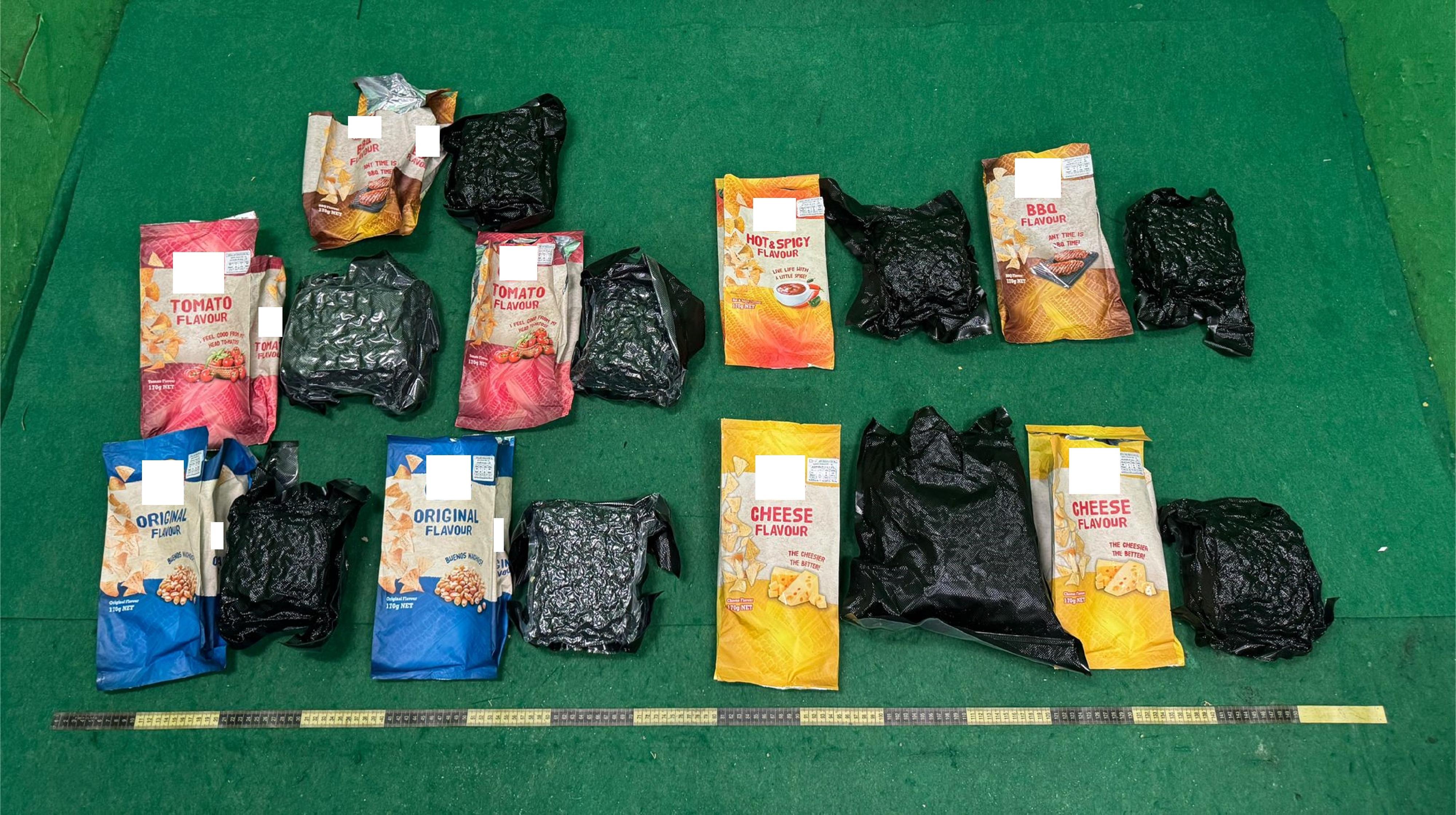Hong Kong Customs today (May 31) detected a drug trafficking case involving baggage concealment at Hong Kong International Airport and seized about 5 kilograms of suspected cannabis buds with an estimated market value of about $0.9 million. Photo shows the suspected cannabis buds concealed in snack packaging.