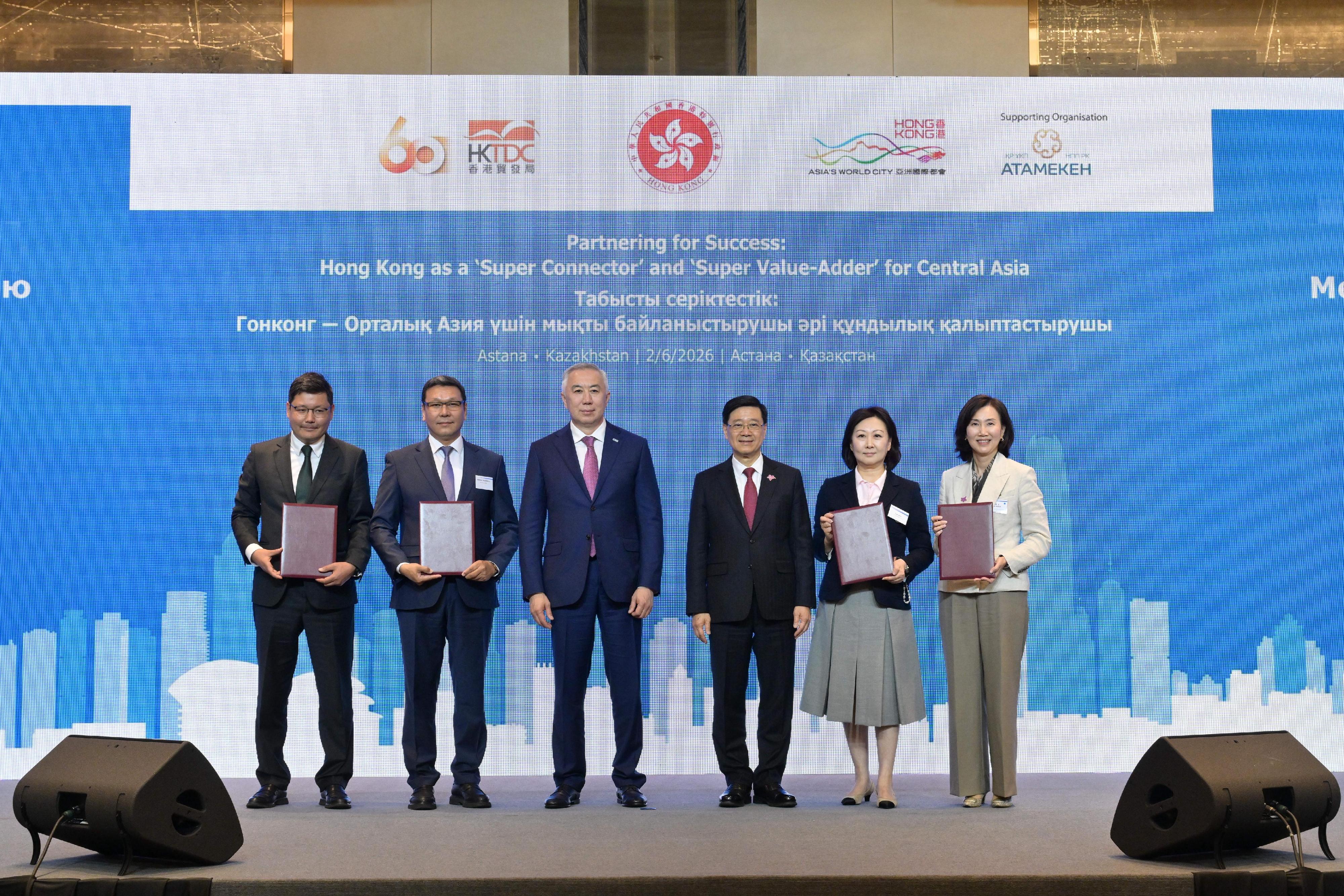 The Chief Executive, Mr John Lee, attended a business luncheon co-organised by the Hong Kong Special Administrative Region Government and the Hong Kong Trade Development Council in Astana, Kazakhstan, today (June 2, Astana time). Photo shows Mr Lee (third right) and Deputy Prime Minister and Minister of National Economy of Kazakhstan, Mr Serik Zhumangarin (third left) witnessing the exchange of Memoranda of Understanding and co-operation agreements between government departments, enterprises and organisations.