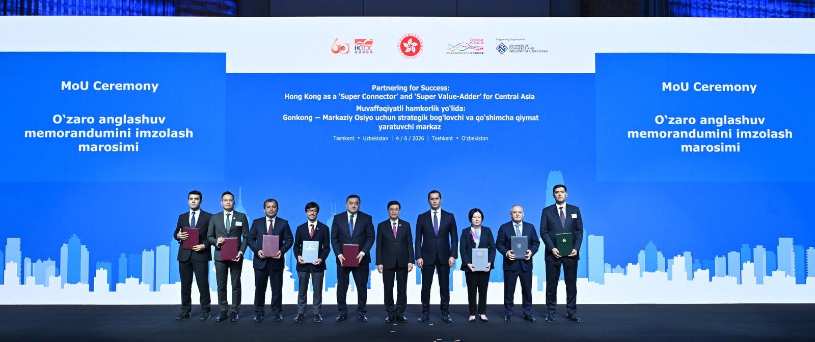 The Chief Executive, Mr John Lee, attended a business dinner and a signing ceremony for Memoranda of Understanding (MOUs) jointly organised by the Hong Kong Special Administrative Region Government and the Hong Kong Trade Development Council in Tashkent, Uzbekistan, today (June 4). Photo shows Mr Lee (fifth right) and the Advisor to the President of Uzbekistan on Strategic Development, Mr Sardor Umurzakov (fourth right) witnessing the exchange of MOUs and co-operation agreements between government departments, enterprises and organisations.