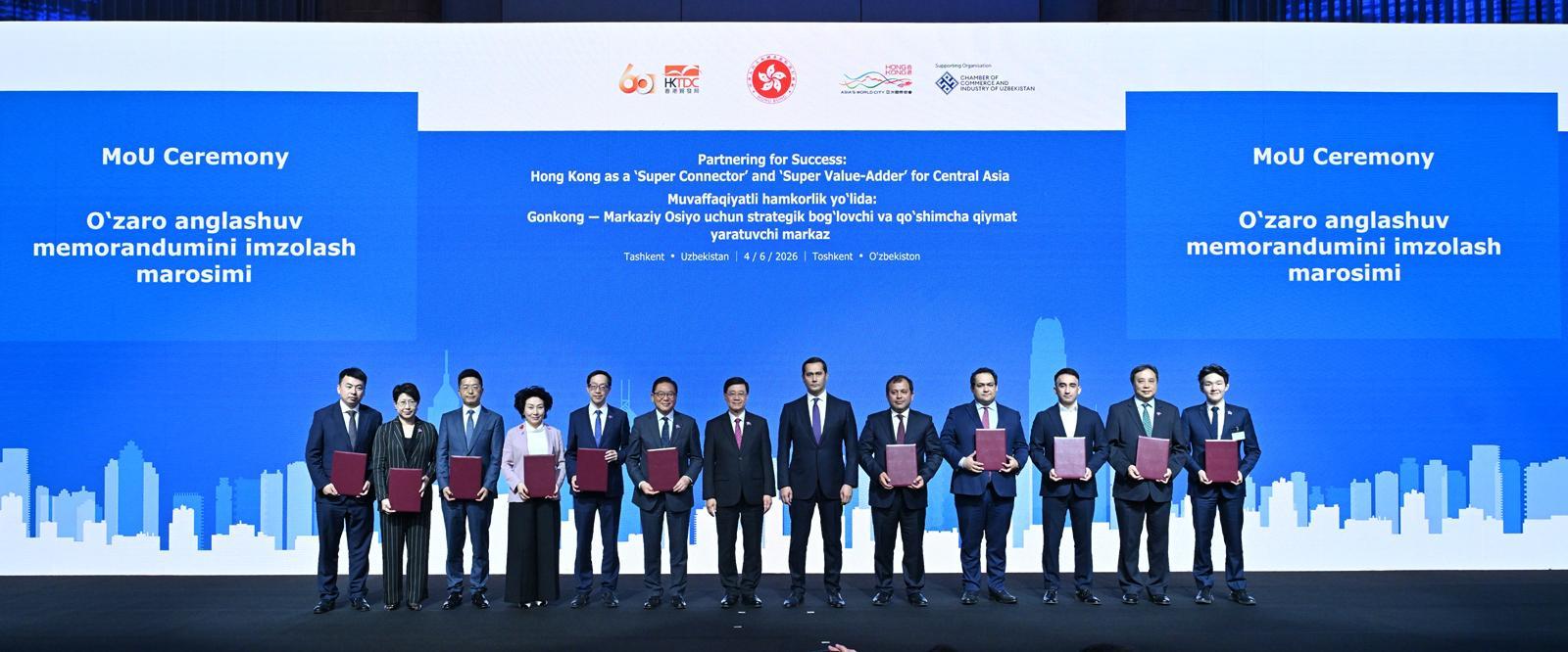 The Chief Executive, Mr John Lee, attended a business dinner and a signing ceremony for Memoranda of Understanding (MOUs) jointly organised by the Hong Kong Special Administrative Region Government and the Hong Kong Trade Development Council in Tashkent, Uzbekistan, today (June 4). Photo shows Mr Lee (centre) and the Advisor to the President of Uzbekistan on Strategic Development, Mr Sardor Umurzakov (sixth right) witnessing the exchange of MOUs and co-operation agreements between government departments, enterprises and organisations.