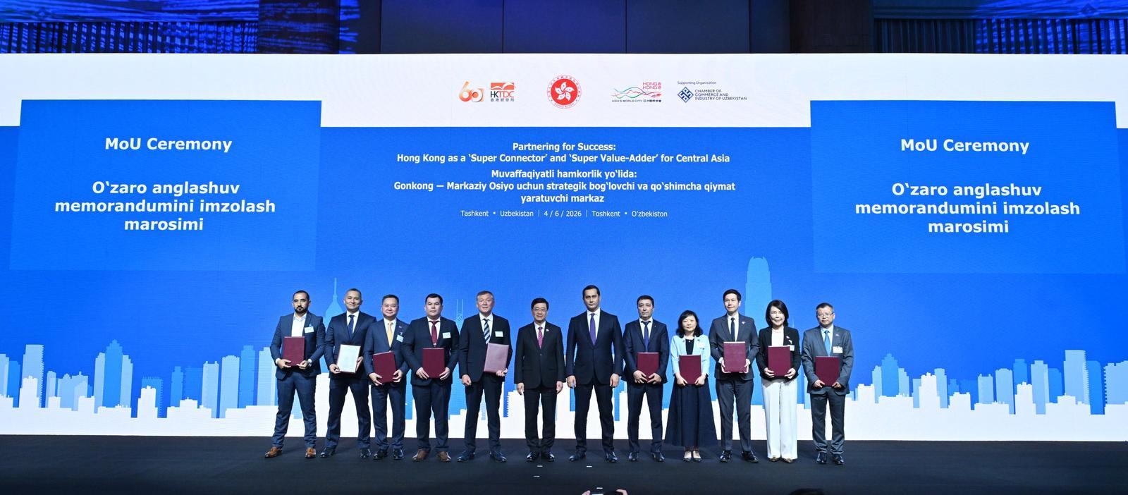 The Chief Executive, Mr John Lee, attended a business dinner and a signing ceremony for Memoranda of Understanding (MOUs) jointly organised by the Hong Kong Special Administrative Region Government and the Hong Kong Trade Development Council in Tashkent, Uzbekistan, today (June 4). Photo shows Mr Lee (sixth left) and the Advisor to the President of Uzbekistan on Strategic Development, Mr Sardor Umurzakov (seventh left) witnessing the exchange of MOUs and co-operation agreements between government departments, enterprises and organisations.