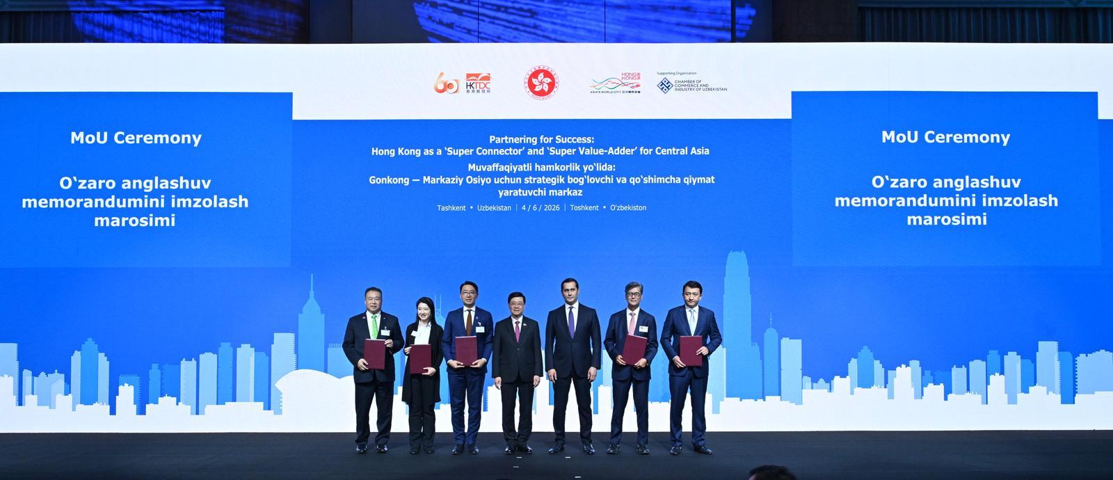 The Chief Executive, Mr John Lee, attended a business dinner and a signing ceremony for Memoranda of Understanding (MOUs) jointly organised by the Hong Kong Special Administrative Region Government and the Hong Kong Trade Development Council in Tashkent, Uzbekistan, today (June 4). Photo shows Mr Lee (centre) and the Advisor to the President of Uzbekistan on Strategic Development, Mr Sardor Umurzakov (third right) witnessing the exchange of MOUs and co-operation agreements between government departments, enterprises and organisations.