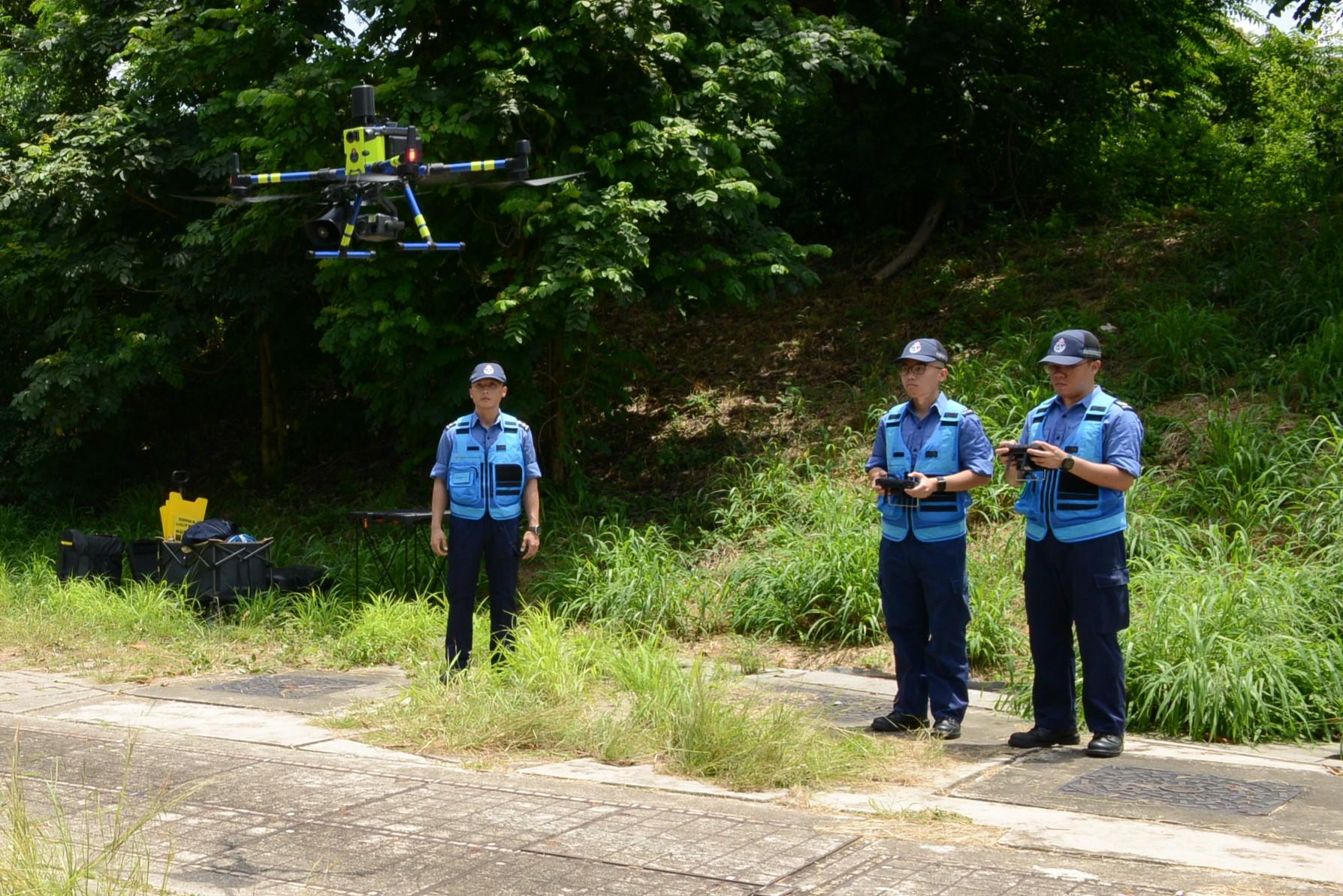 The Civil Aid Service (CAS) organised an exercise today (June 7) to enhance its response and rescue capabilities during extreme weather. Photo shows a CAS member operating a rescue drone.