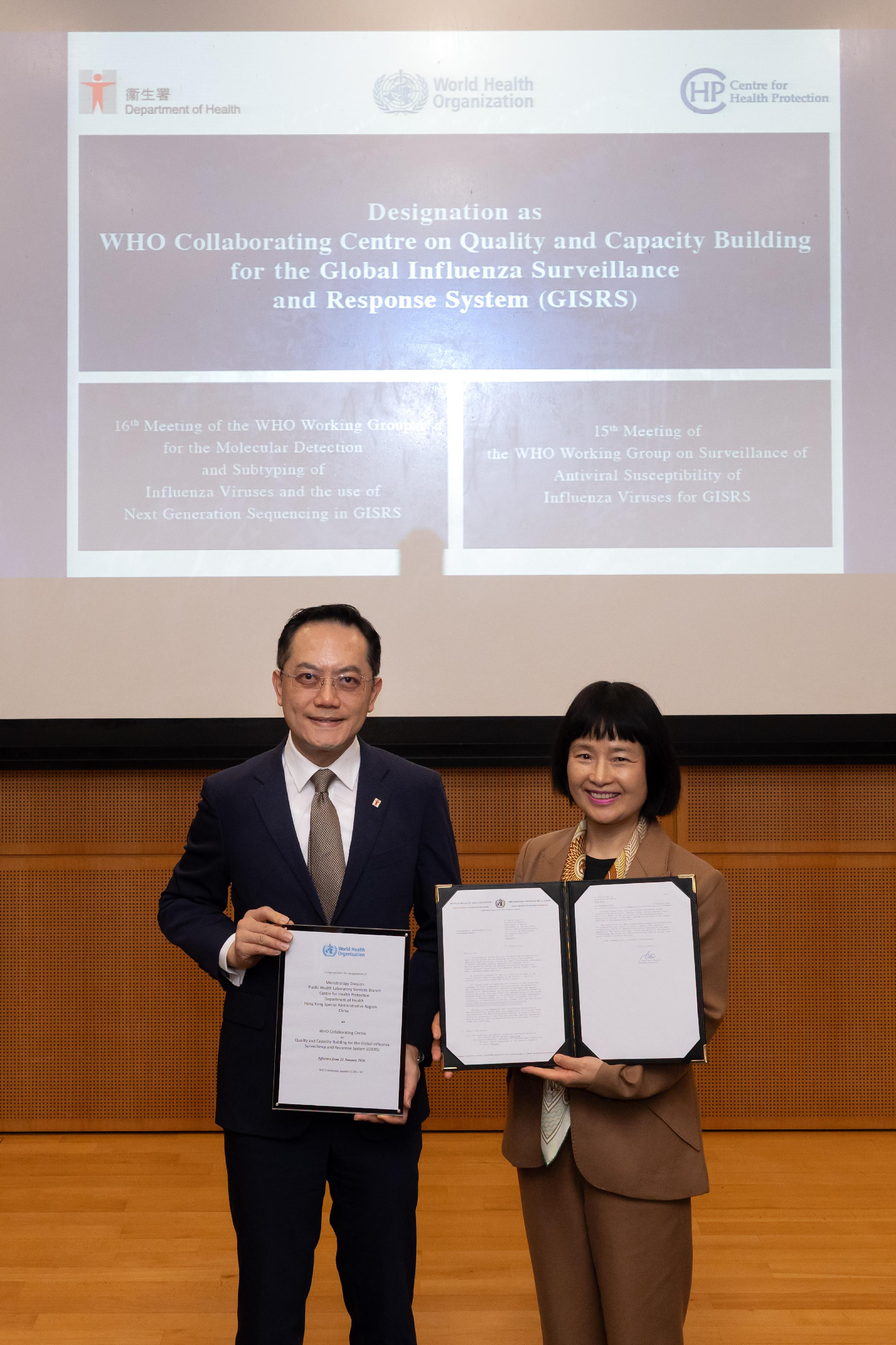 The Microbiology Division of the Public Health Laboratory Services Branch, which is under the Centre for Health Protection of the Department of Health (DH), has been designated by the World Health Organization (WHO) as a Collaborating Centre on Quality and Capacity Building for the Global Influenza Surveillance and Response System. This is the second WHO Collaborating Centre in China to combat influenza. The WHO representative formally presented the designation letter to the DH in Hong Kong today (June 8). Photo shows the Head of Global Respiratory Threats of the WHO, Dr Zhang Wenqing (right), with the Director of Health, Dr Ronald Lam (left), after presenting the letter of designation to the DH.