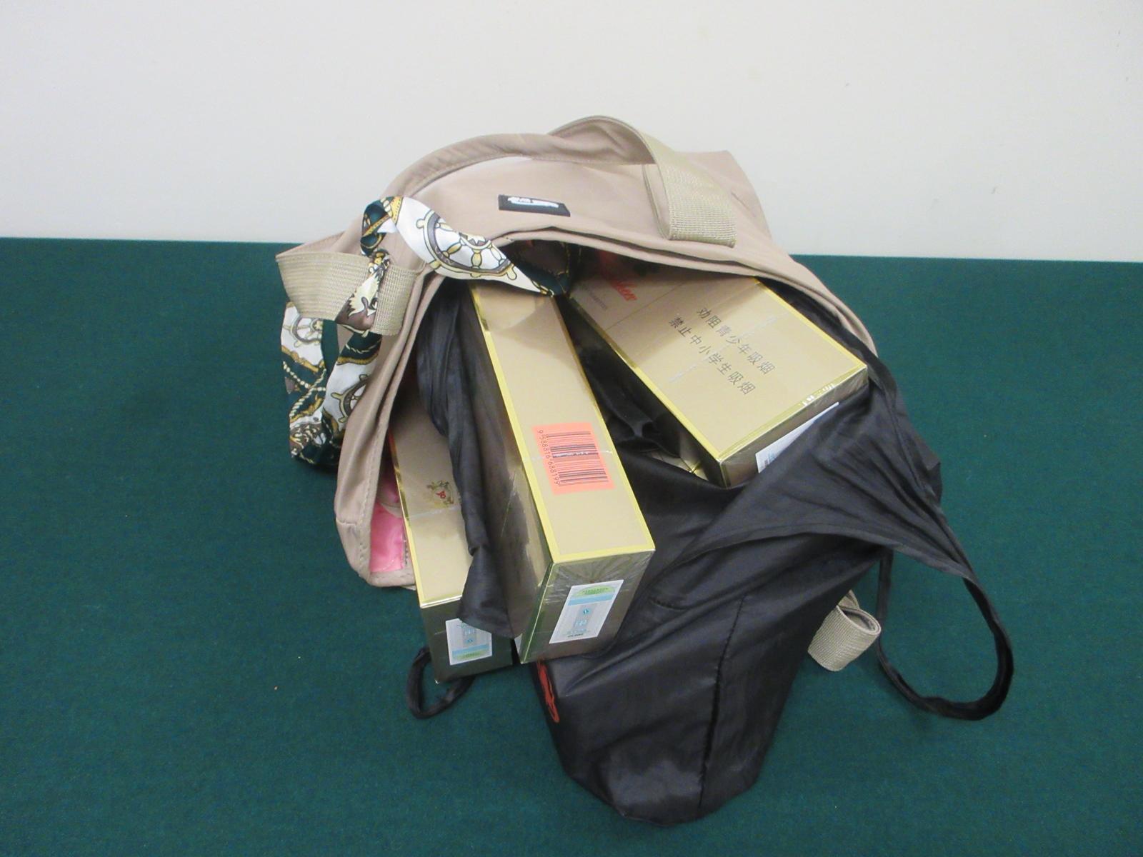 Two incoming passengers were each sentenced to four weeks' imprisonment with a fine of $1,000 by the Fanling Magistrates' Courts today (June 8) for possessing duty-not-paid cigarettes and failing to declare them to Customs officers in contravention of the Dutiable Commodities Ordinance. Photo shows the duty-not-paid cigarettes seized from the personal baggage of the 43-year-old incoming female passenger.