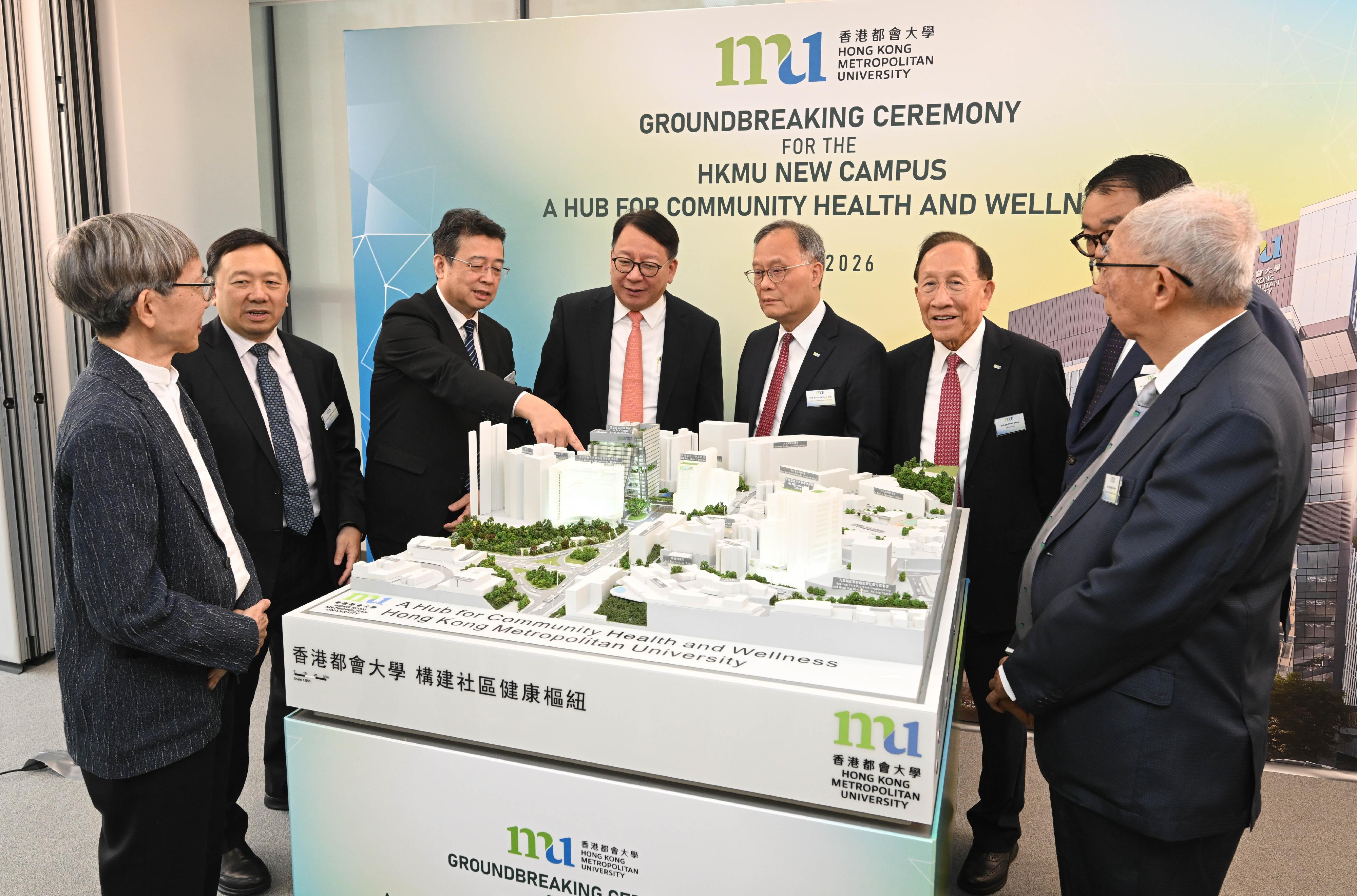 The Chief Secretary for Administration, Mr Chan Kwok-ki, attended the Groundbreaking Ceremony for the HKMU (Hong Kong Metropolitan University) New Campus - A Hub for Community Health and Wellness today (June 9). Photo shows Mr Chan (fourth left) viewing a 3D campus model. Looking on are the Pro-Chancellor of the HKMU, Dr Eddy Fong (third right); the Council Chairman of the HKMU, Dr Conrad Wong (second left); and the President of the HKMU, Professor Paul Lam (fourth right).