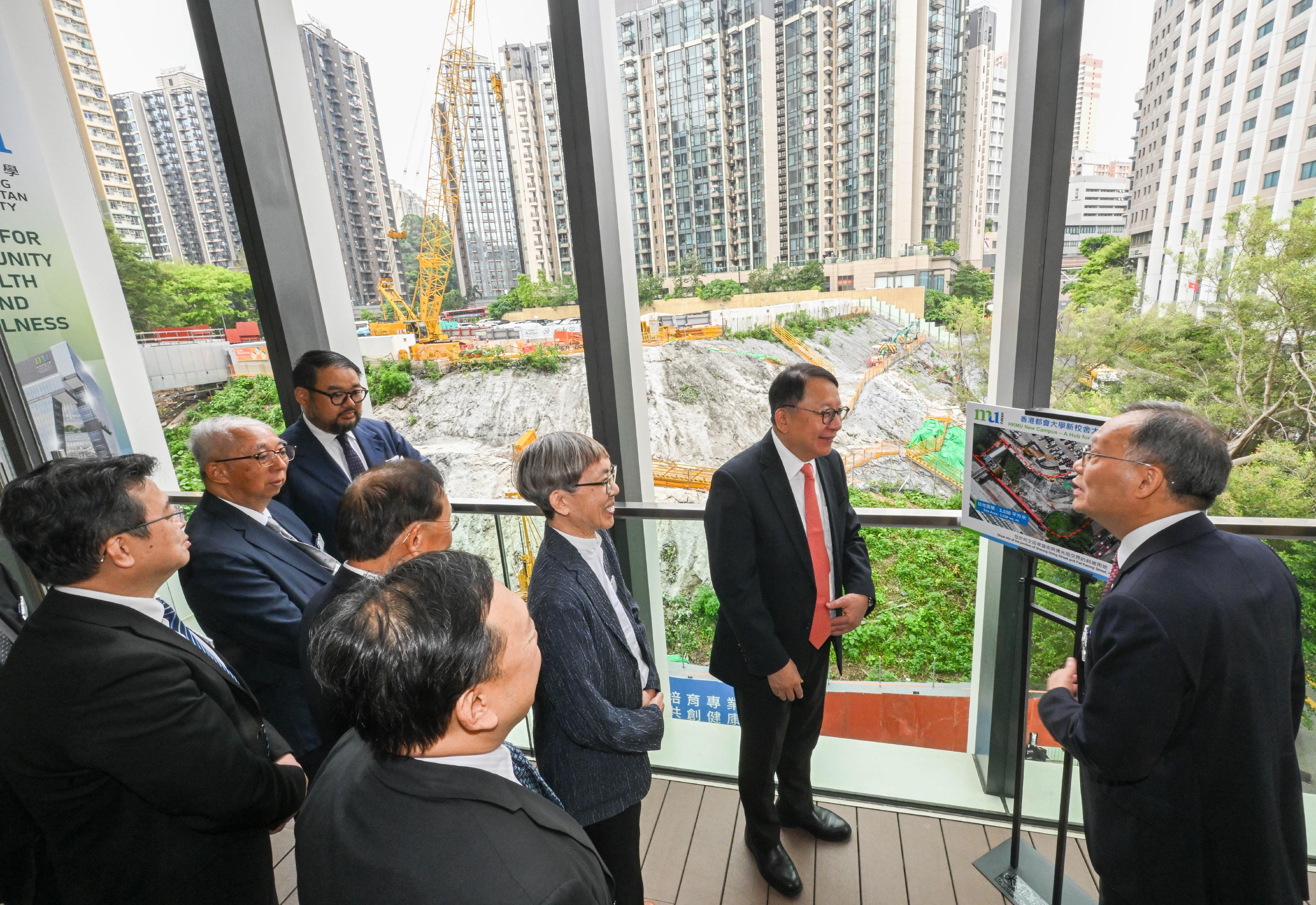 The Chief Secretary for Administration, Mr Chan Kwok-ki, attended the Groundbreaking Ceremony for the HKMU (Hong Kong Metropolitan University) New Campus - A Hub for Community Health and Wellness today (June 9). Photo shows Mr Chan (second right) viewing the construction site. Looking on is the President of the HKMU, Professor Paul Lam (first right).
