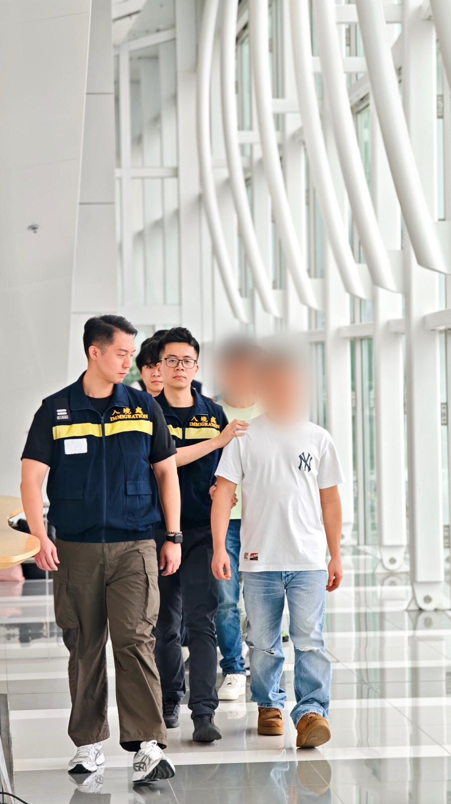 The Immigration Department (ImmD) carried out a repatriation operation today (June 12). A total of 35 Vietnamese illegal immigrants and overstayers were repatriated to Vietnam. Photo shows removees being escorted by ImmD officers to depart from Hong Kong.