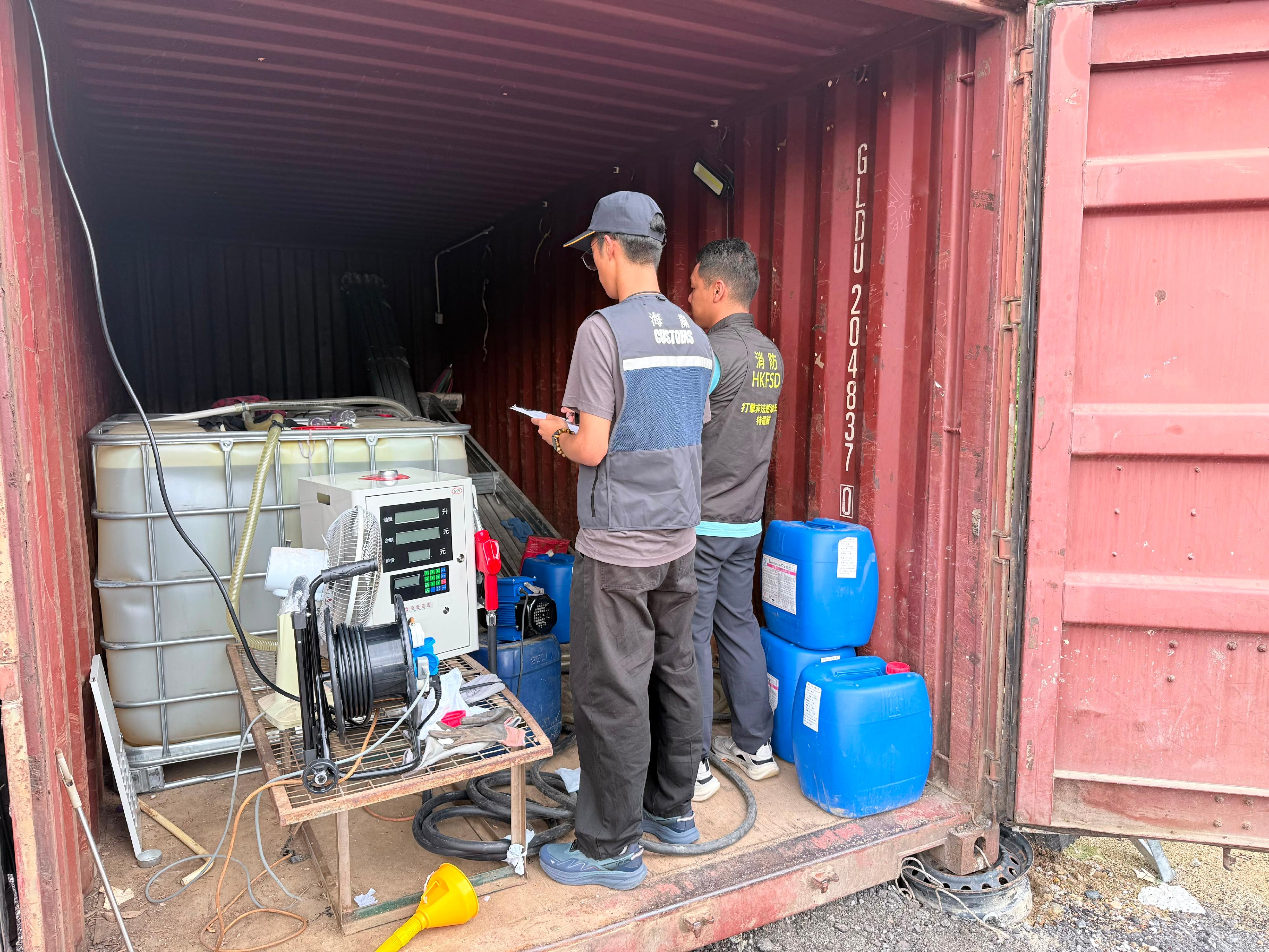 香港海關聯同消防處於六月十日在全港各區進行突擊行動,打擊非法燃油活動。行動中,雙方人員共偵破兩宗相關案件,檢獲共約三千二百公升未完稅汽油,估計市值約十萬四千元,應課稅值約二萬元,並拘捕兩人及檢獲一輛涉案車輛。圖示一個在東涌搗破的非法加油站。