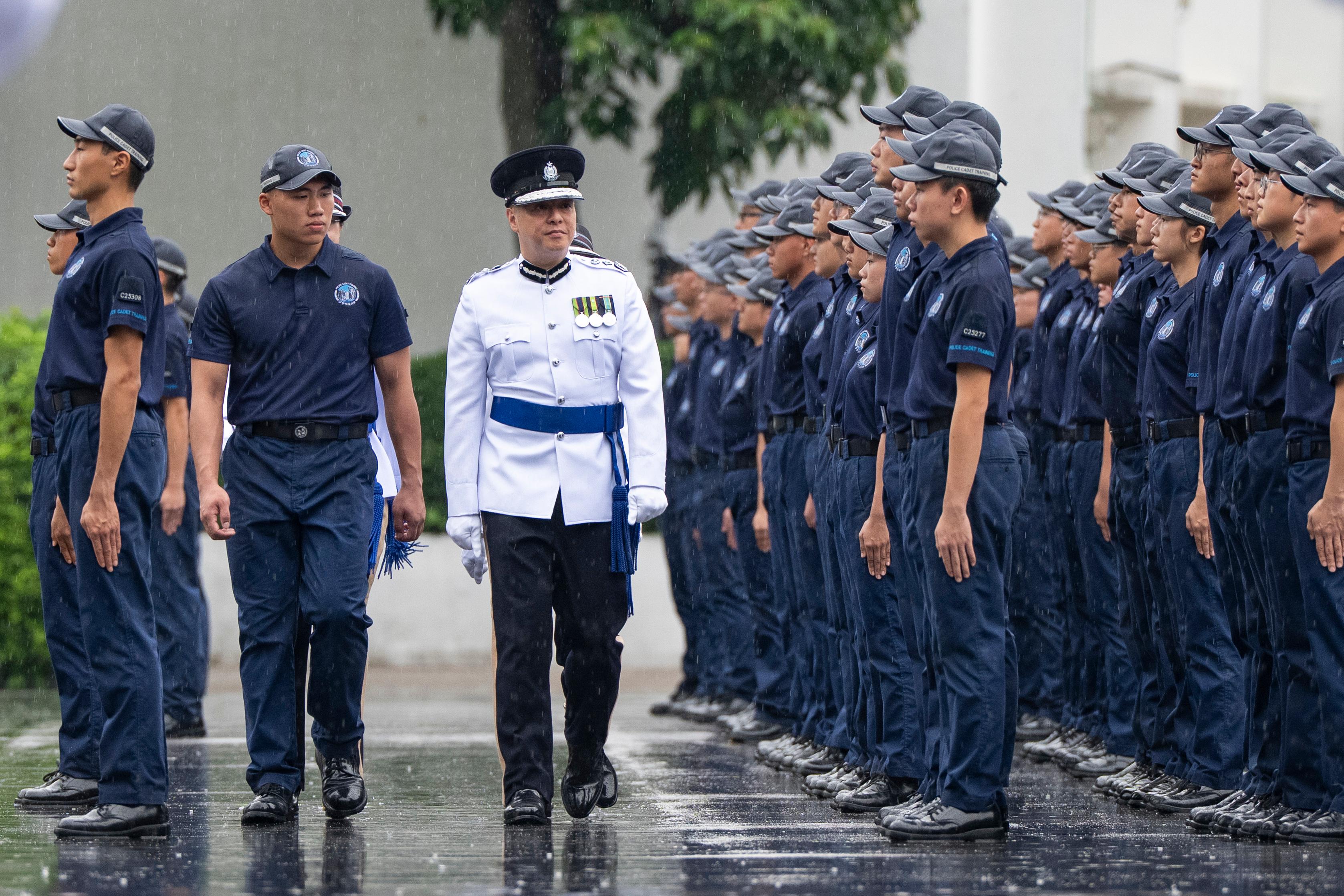 The Commissioner of Police, Mr Chow Yat-ming, inspects a passing-out parade of the Police Cadet Training for 159 cadets as reviewing officer at the Hong Kong Police College today (June 13).