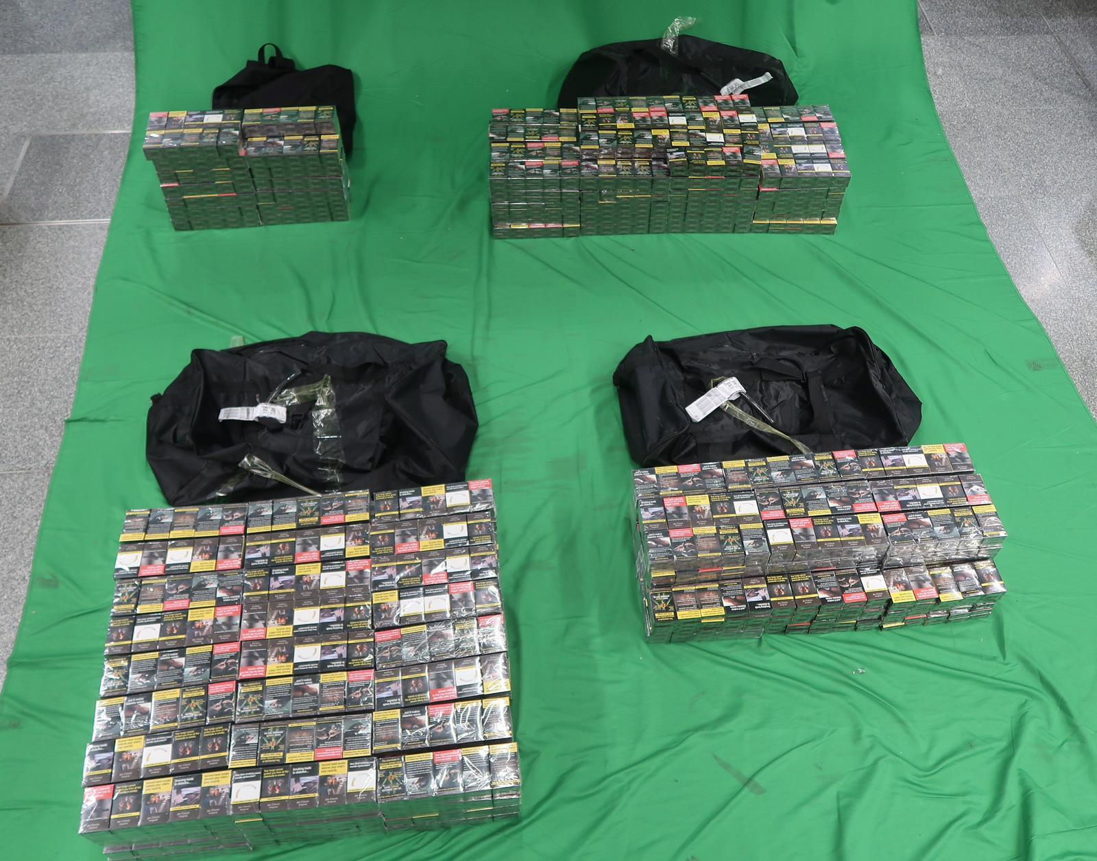 Two incoming Chinese men were sentenced to 28 to 31 weeks of imprisonment respectively, and each fined $2,000, by the West Kowloon Magistrates' Courts today (June 13) for importing duty-not-paid cigarettes and failing to declare them to Customs officers, in contravention of the Dutiable Commodities Ordinance. Photo shows the duty-not-paid cigarettes seized from the personal baggage of the 44-year-old incoming Chinese male passenger.