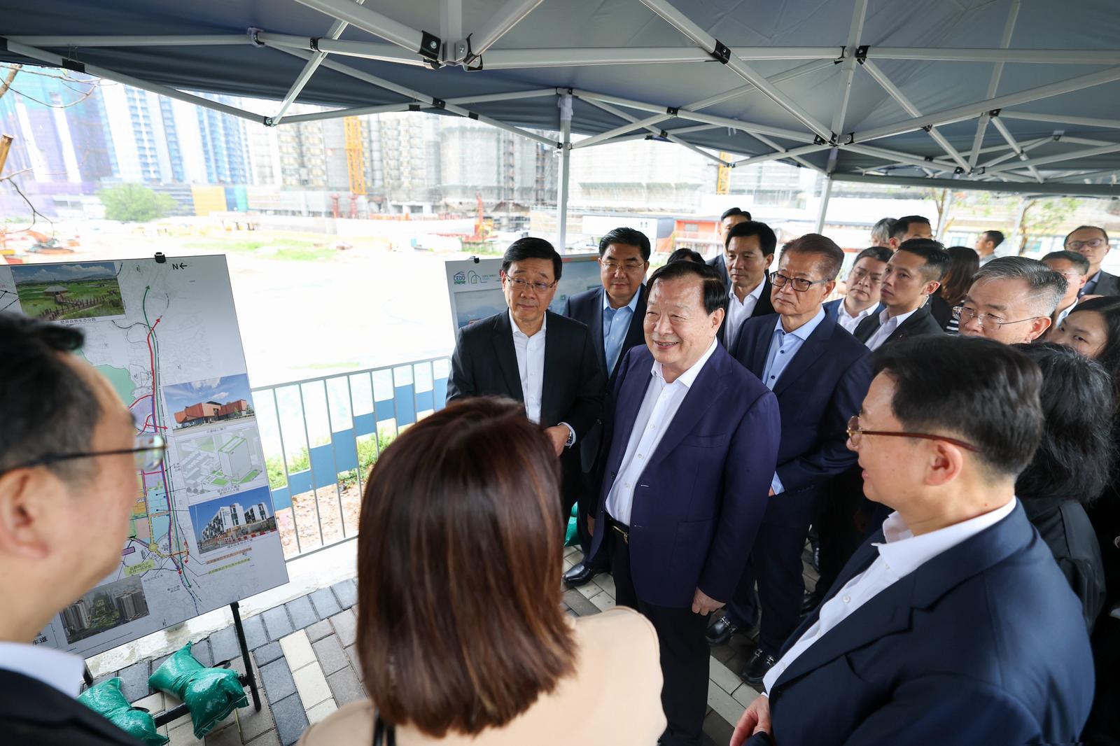 The Director of the Hong Kong and Macao Work Office of the Communist Party of China Central Committee and the Hong Kong and Macao Affairs Office of the State Council, Mr Xia Baolong (front row, second left), today (June 16) visits the Kwu Tung North New Development Area, in the company of the Chief Executive, Mr John Lee (front row, first left).