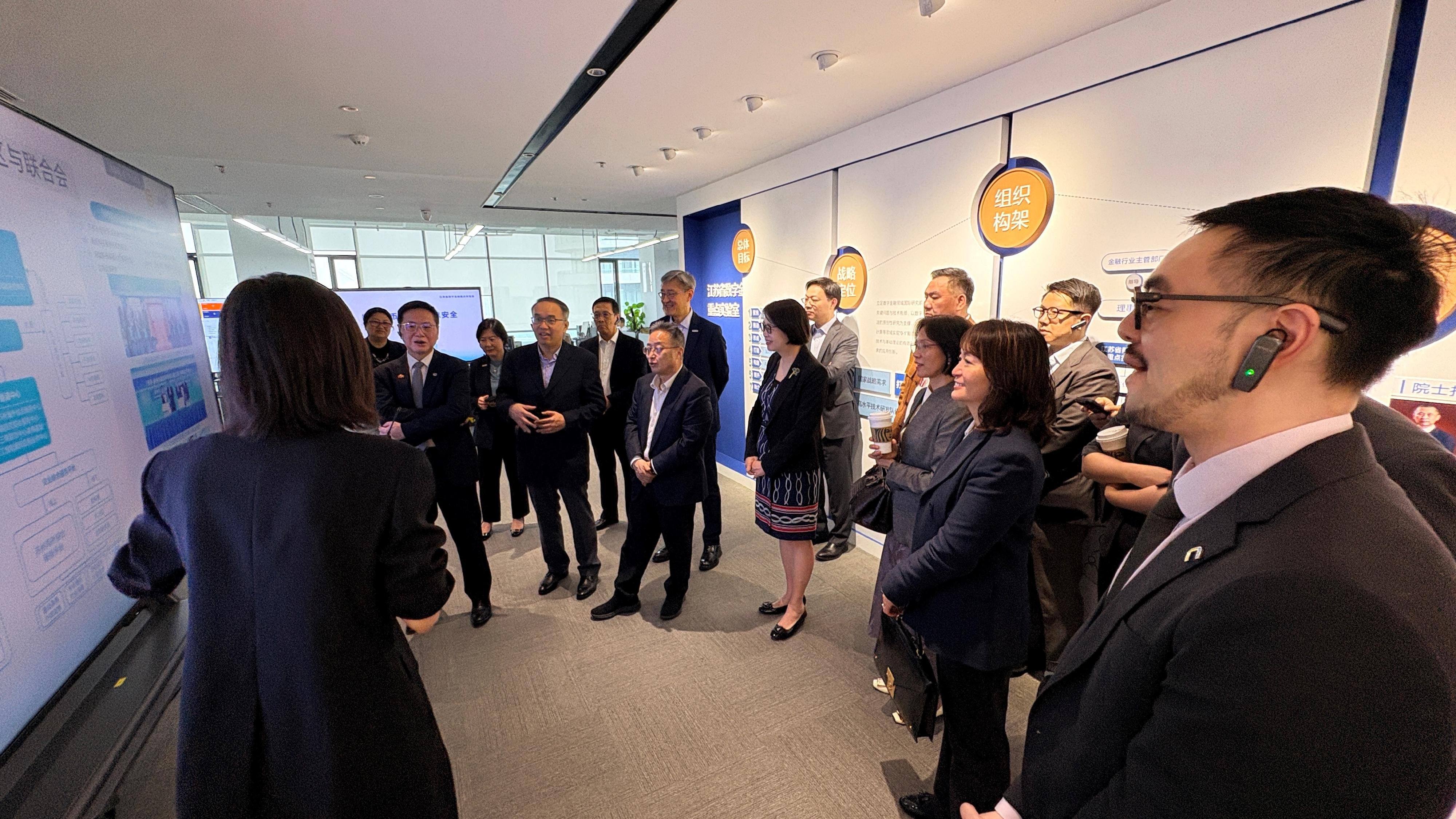 The Secretary for Financial Services and the Treasury, Mr Christopher Hui, and the financial delegation began their visit to Suzhou yesterday (June 16). Photo shows Mr Hui (front row, second left); the Permanent Secretary for Financial Services and the Treasury (Financial Services), Mrs Angelina Cheung (front row, fourth left); the Director of the Hong Kong Economic and Trade Office in Shanghai, Ms Veronica Wong (front row, second right), and members of the delegation touring a key laboratory on digital finance at Jiangsu Jinfu Digital Tech Group Company Limited. Also present is member of the Standing Committee of the CPC Suzhou Municipal Committee and Executive Vice Mayor of the Suzhou Municipal People's Government, Jiangsu Province, Mr Gu Haidong (front row, third left).