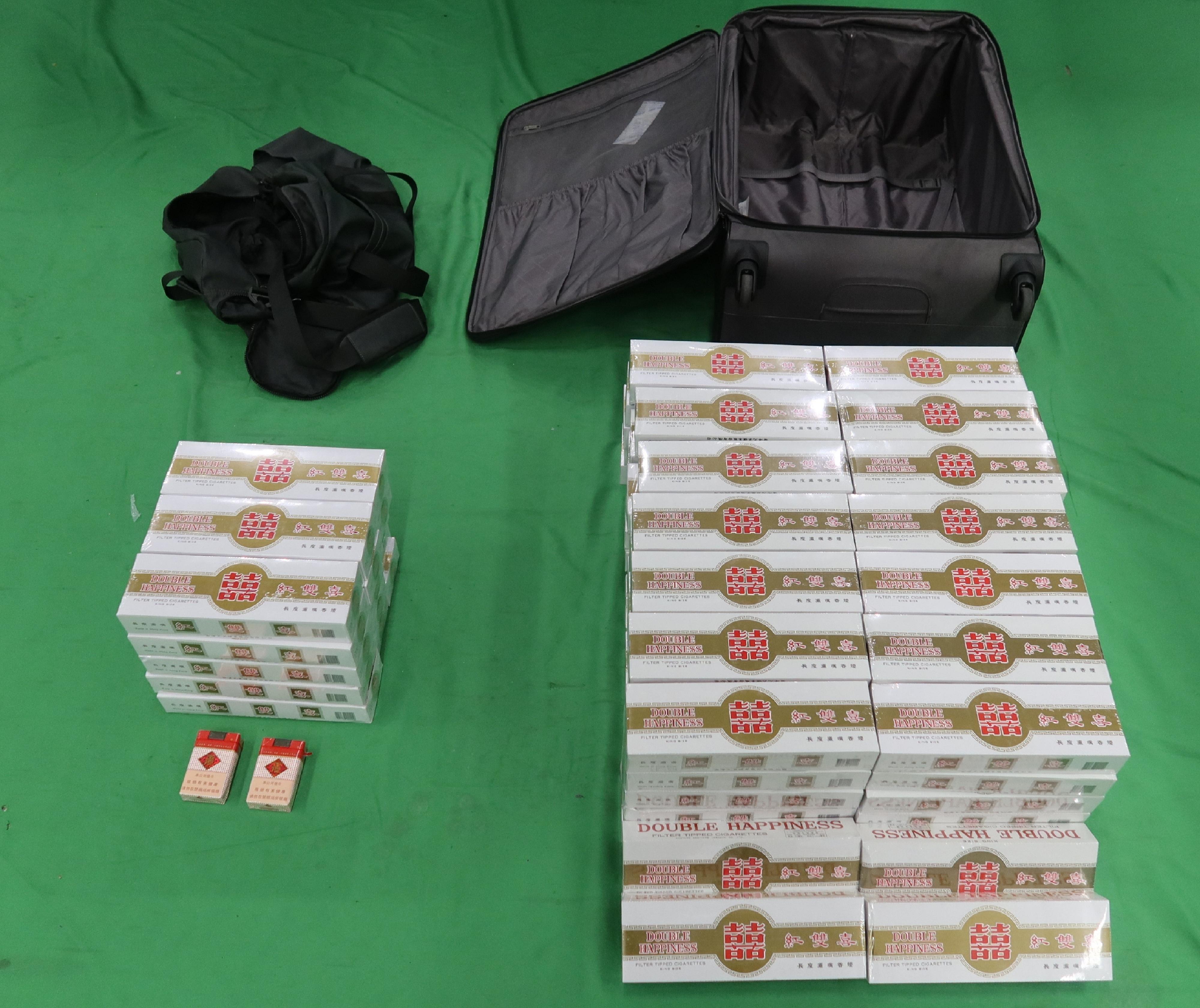 Two incoming male passengers were sentenced to four weeks’ imprisonment with a fine of $1,000, and three months' imprisonment with a fine of $1,000, respectively by the Courts today (June 22) for possessing or importing duty-not-paid cigarettes and failing to declare them to Customs officers, in contravention of the Dutiable Commodities Ordinance. Photo shows the duty-not-paid cigarettes seized from the personal baggage of an incoming 44-year-old Chinese male passenger.