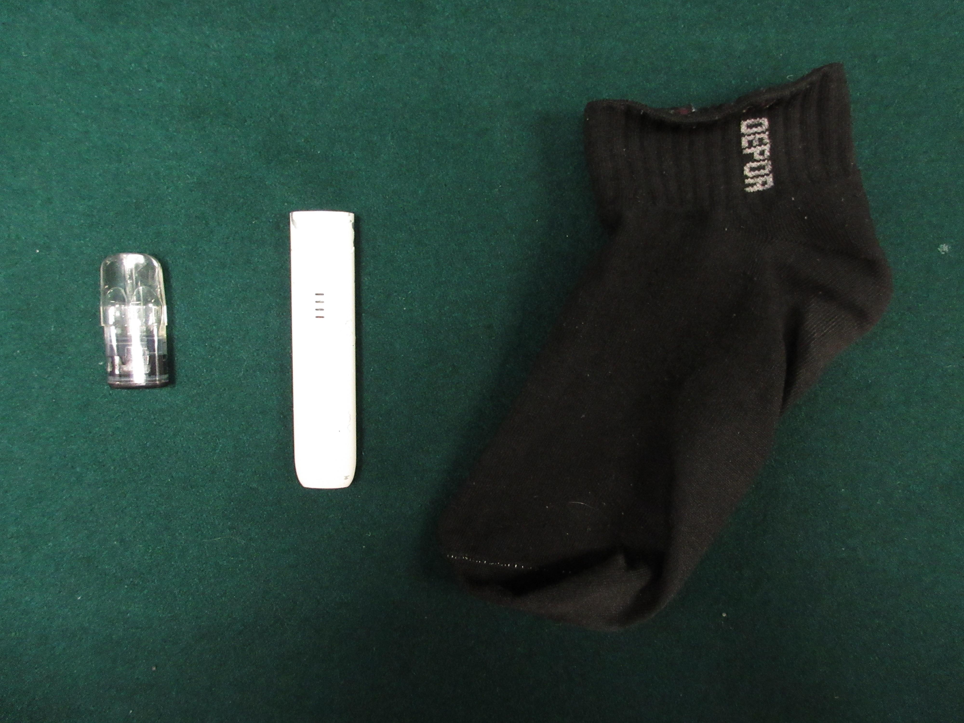 Hong Kong Customs detected a suspected dangerous drugs trafficking case on June 19 at the Lo Wu Control Point. Photo shows a suspected etomidate capsule and an e-cigarette smoking device concealed in a sock.