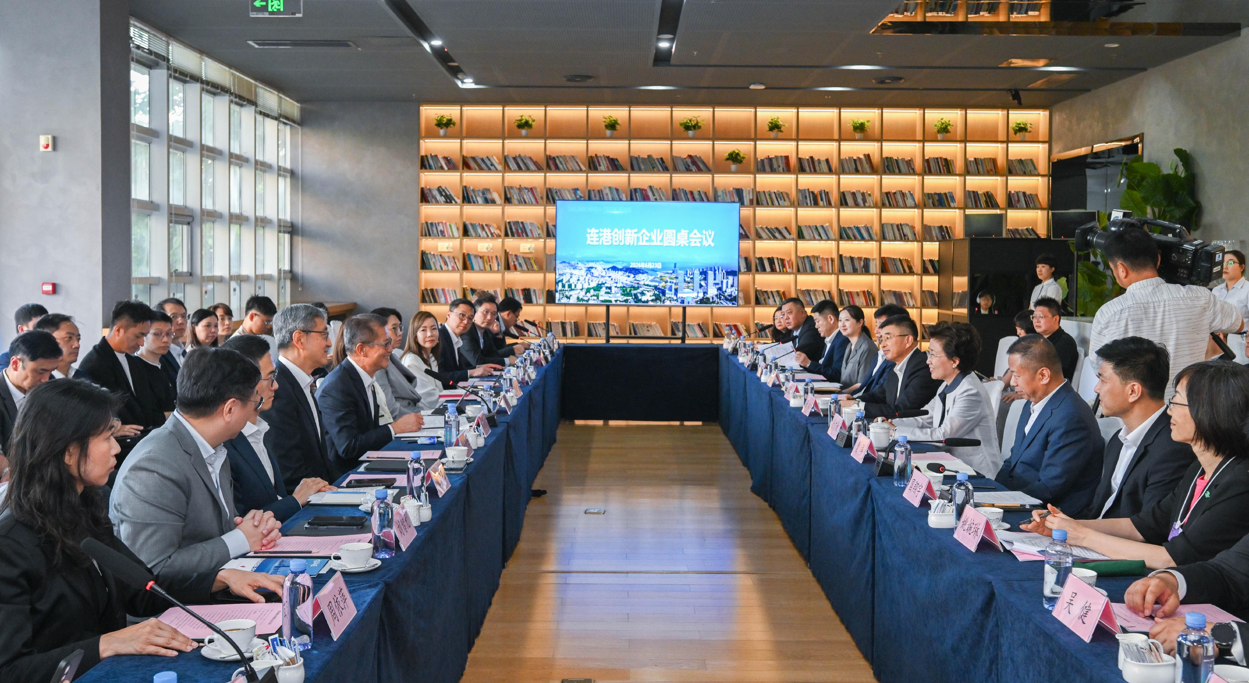 The Financial Secretary, Mr Paul Chan, attended the World Economic Forum's Annual Meeting of the New Champions 2026 in Dalian today (June 23). Photo shows Mr Chan (fifth left) with the Hong Kong delegation of innovation and technology (I&T) enterprises visiting the Dalian High-Tech Industrial Zone during a roundtable meeting with I&T enterprises from the two places.