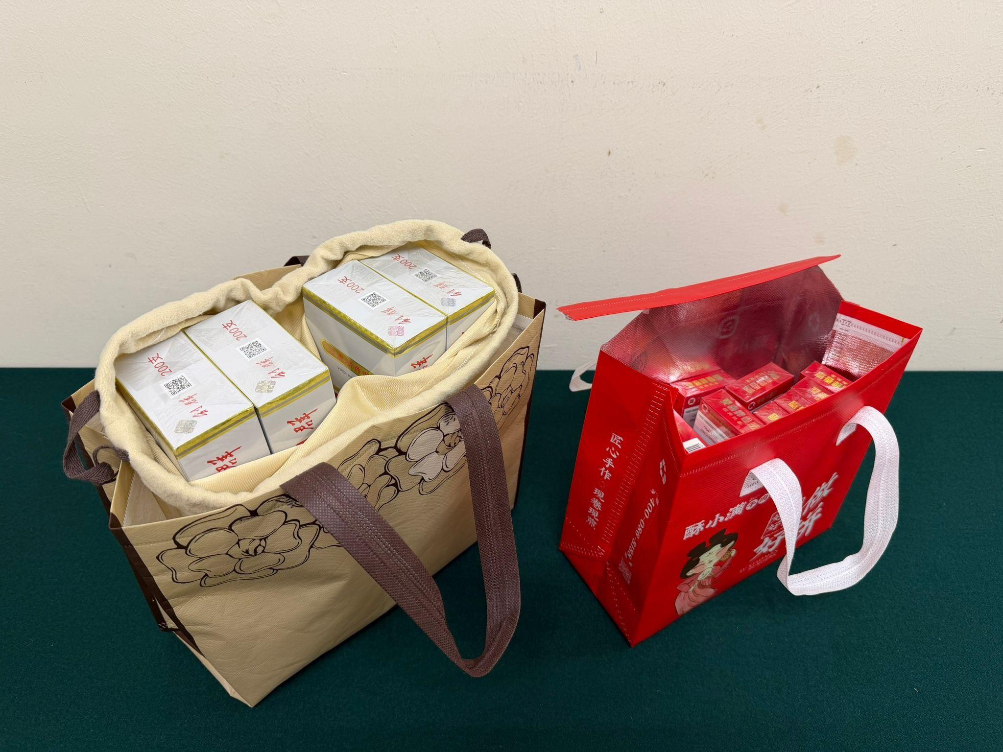 Two incoming female passengers were sentenced to three months' imprisonment with a fine of $1,000, and six weeks' imprisonment with a fine of $2,000, respectively, by the Fanling Magistrates Courts today (June 23) for importing or possessing duty-not-paid cigarettes and failing to declare to Customs officers, in contravention of the Dutiable Commodities Ordinance. Photo shows the duty-not-paid cigarettes seized by Customs officers from the personal baggage of an incoming 49-year-old local female passenger in the second interception.
