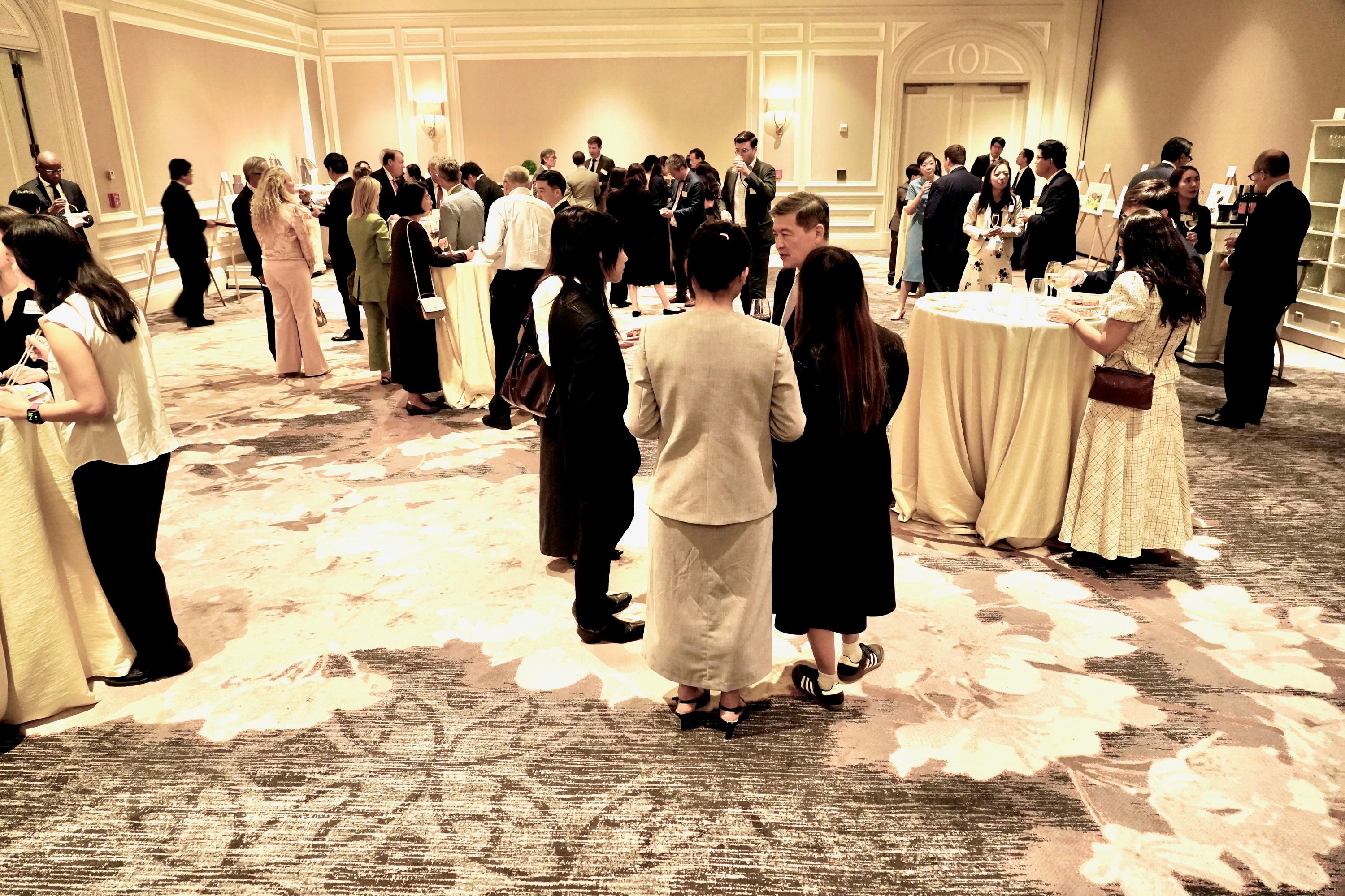 Attendees network during a post-event reception.