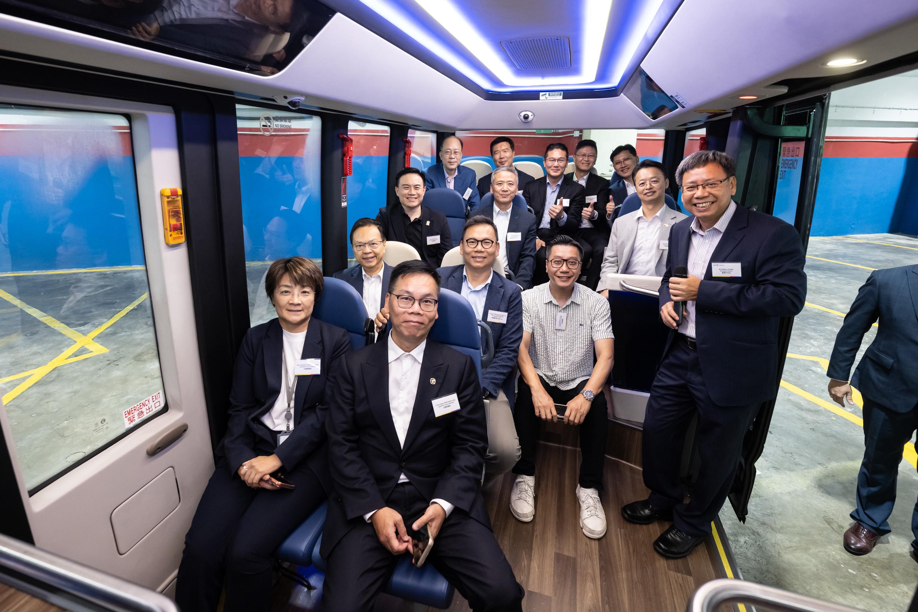 The Legislative Council (LegCo) Panel on Transport visited the Citybus Limited (Citybus) depot and the first autonomous minibus introduced by the company today (June 29). Photo shows LegCo Members observing the autonomous minibus introduced by Citybus.