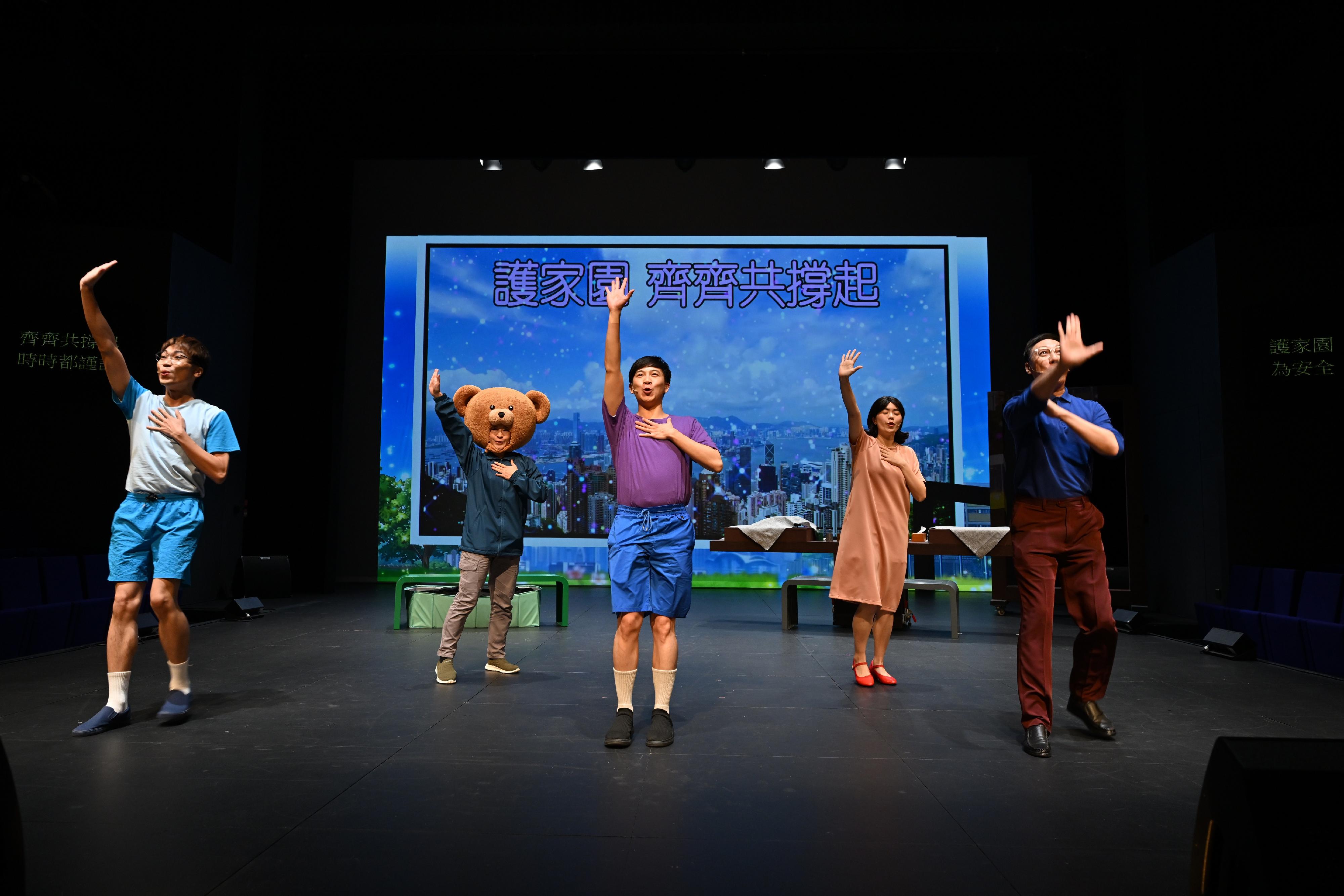The Security Bureau today (July 3) held the launch ceremony and staging of "The 6th Anniversary of the promulgation and implementation of the Hong Kong National Security Law Security Bureau presents: National Security Interactive Drama - 'Community Chef Challenge: Security Brings Prosperity'". Photo shows the cast members performing energetically to convey the key message of "security brings prosperity".