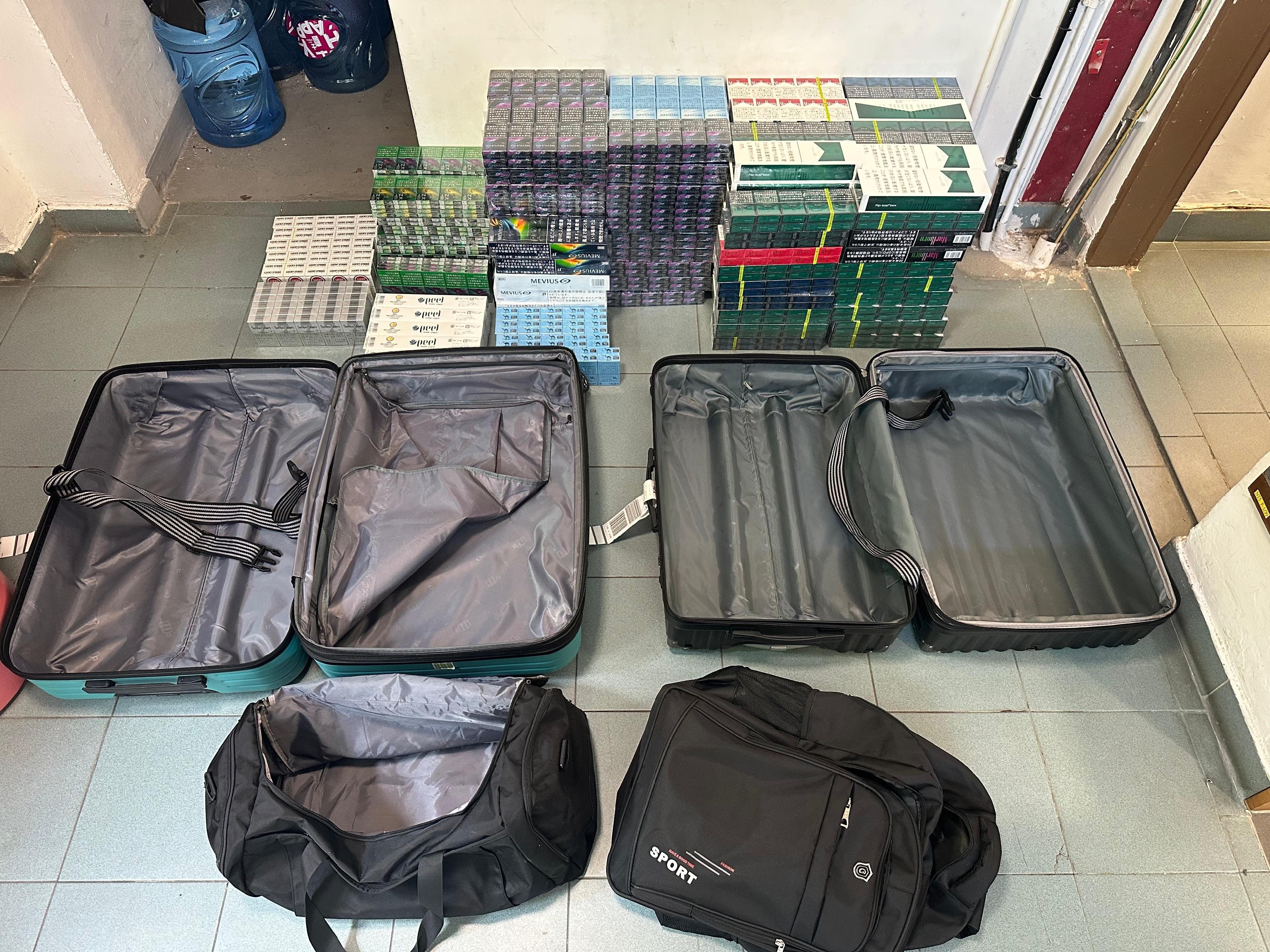 Two incoming air passengers were each sentenced to five months' imprisonment by the West Kowloon Magistrates' Courts on July 4 for importing and dealing with duty-not-paid cigarettes, in contravention of the Dutiable Commodities Ordinance (Cap. 109). One of them was also fined $1,000. Photo shows the illicit cigarettes seized from the personal baggage of one of the incoming air passengers.