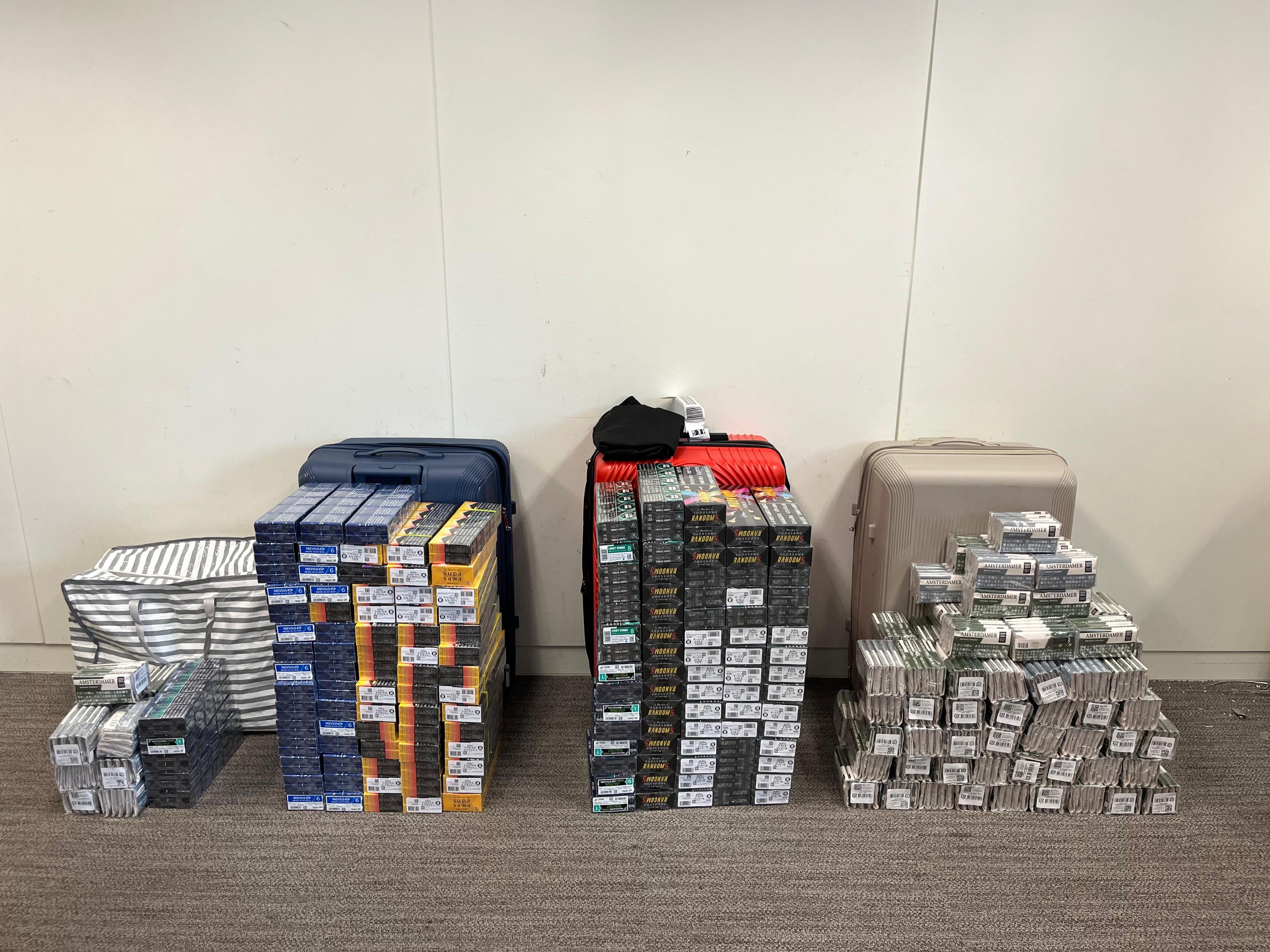Two incoming air passengers were each sentenced to five months' imprisonment by the West Kowloon Magistrates' Courts on July 4 for importing and dealing with duty-not-paid cigarettes, in contravention of the Dutiable Commodities Ordinance (Cap. 109). One of them was also fined $1,000. Photo shows the illicit cigarettes and manufactured tobacco seized from the personal baggage of one of the incoming air passengers.