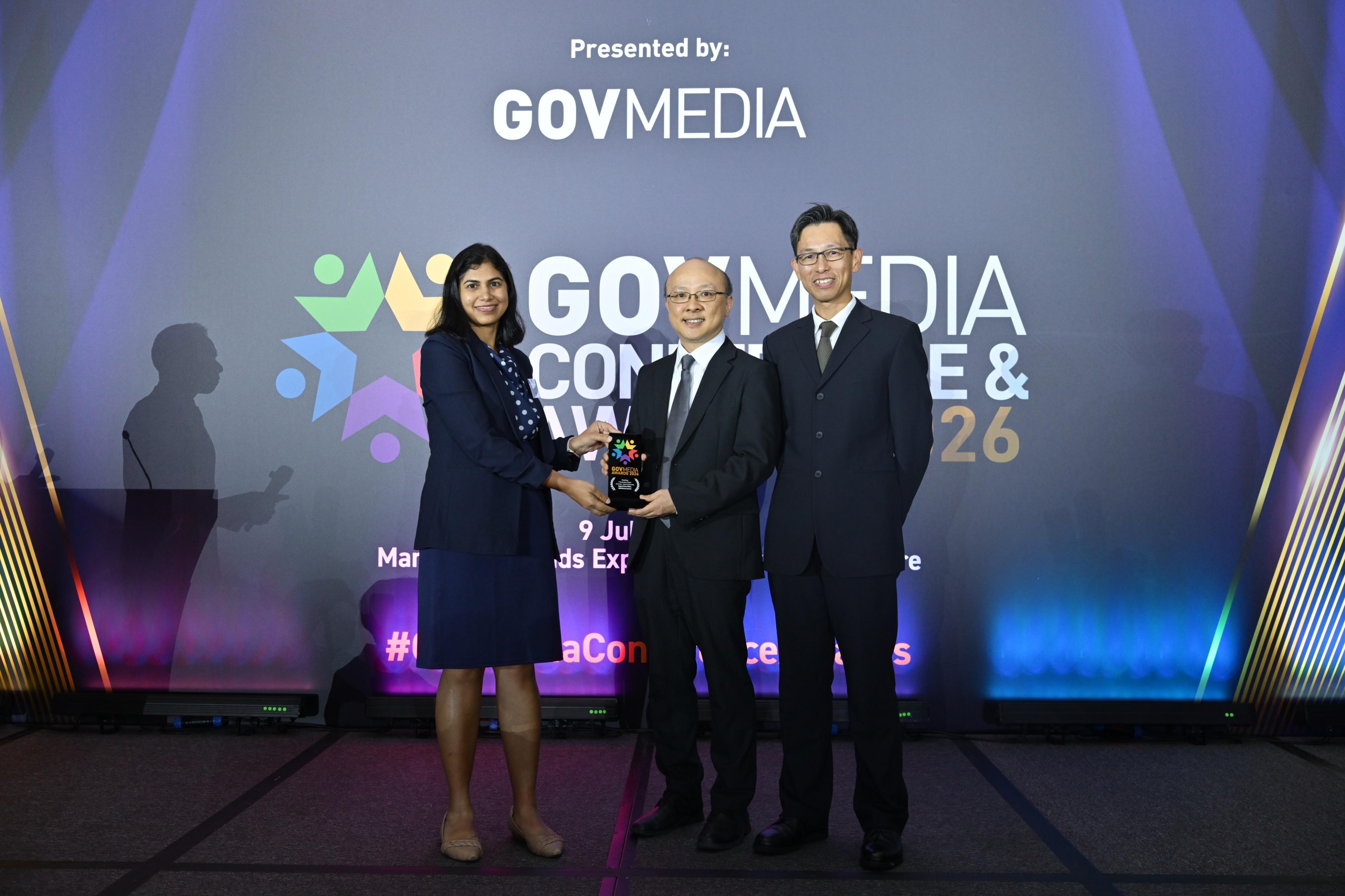 數字政策辦公室的「智方便」一站式數字服務平台昨日(七月九日)於GovMedia Awards 2026頒獎典禮上,榮獲「年度香港電子政務項目—智慧政府」獎項。圖示總系統經理(數據應用)黎伯翔(中)和系統經理(數據應用)曾憲文(右)出席頒獎典禮領獎。