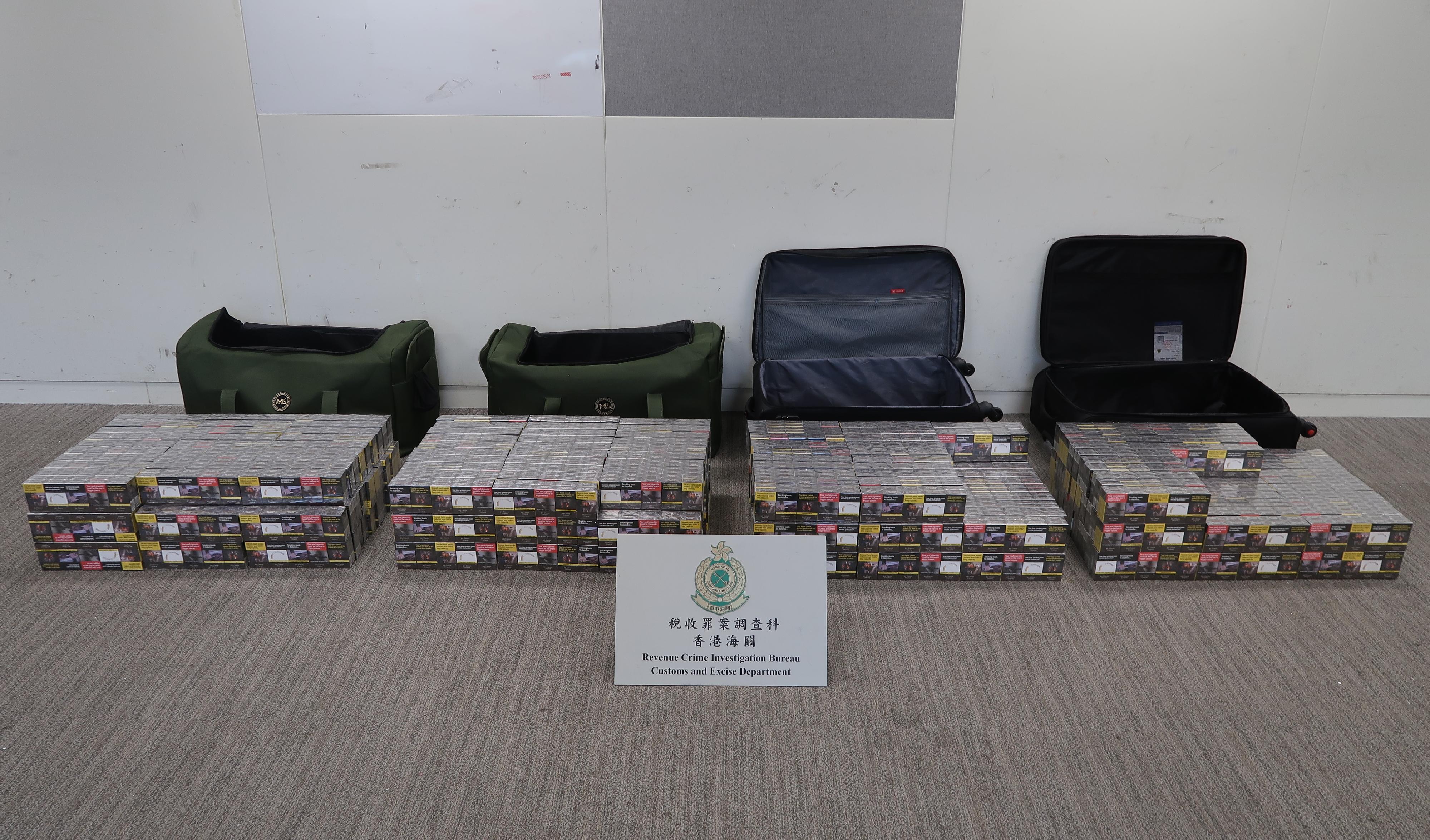 Two incoming air passengers were each sentenced to eight months' imprisonment by the West Kowloon Magistrates' Courts today (July 10) for dealing with duty-not-paid cigarettes, in contravention of the Dutiable Commodities Ordinance (Cap. 109). Photo shows the illicit cigarettes seized from the personal baggage of one of the incoming passengers.