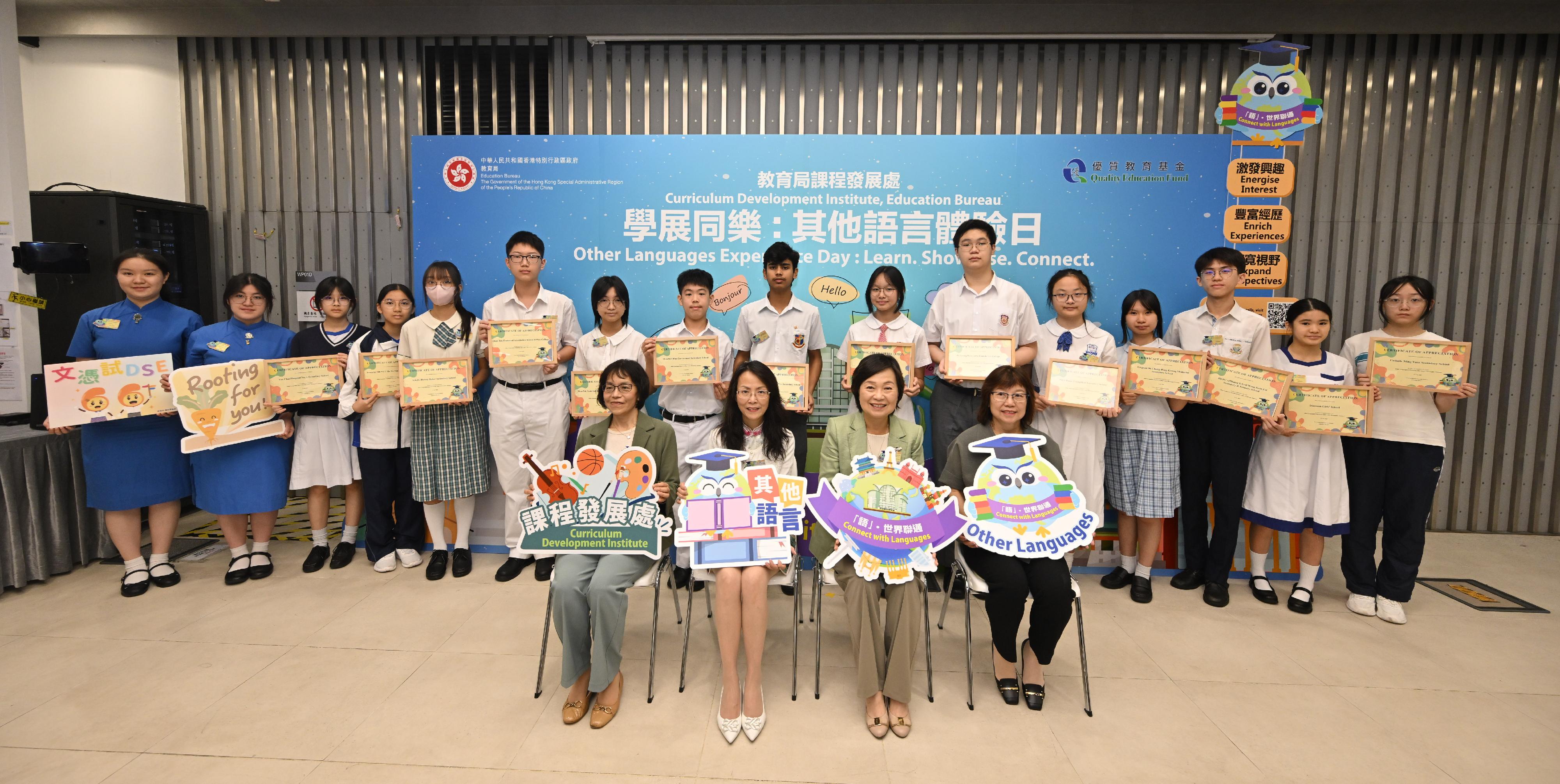 The Education Bureau held the "Other Languages Experience Day: Learn. Showcase. Connect." today (July 11). Photo shows the Secretary for Education, Dr Choi Yuk-lin (front row, second right); Deputy Secretary for Education, Dr Gloria Chan (front row, first right); Principal Assistant Secretary for Education (Curriculum Development), Ms Yvonne Lam (front row, first left); and member of the Quality Education Fund Steering Committee, Ms Lee Yi-ying (front row, second left), in a group picture with Other Languages student ambassadors.