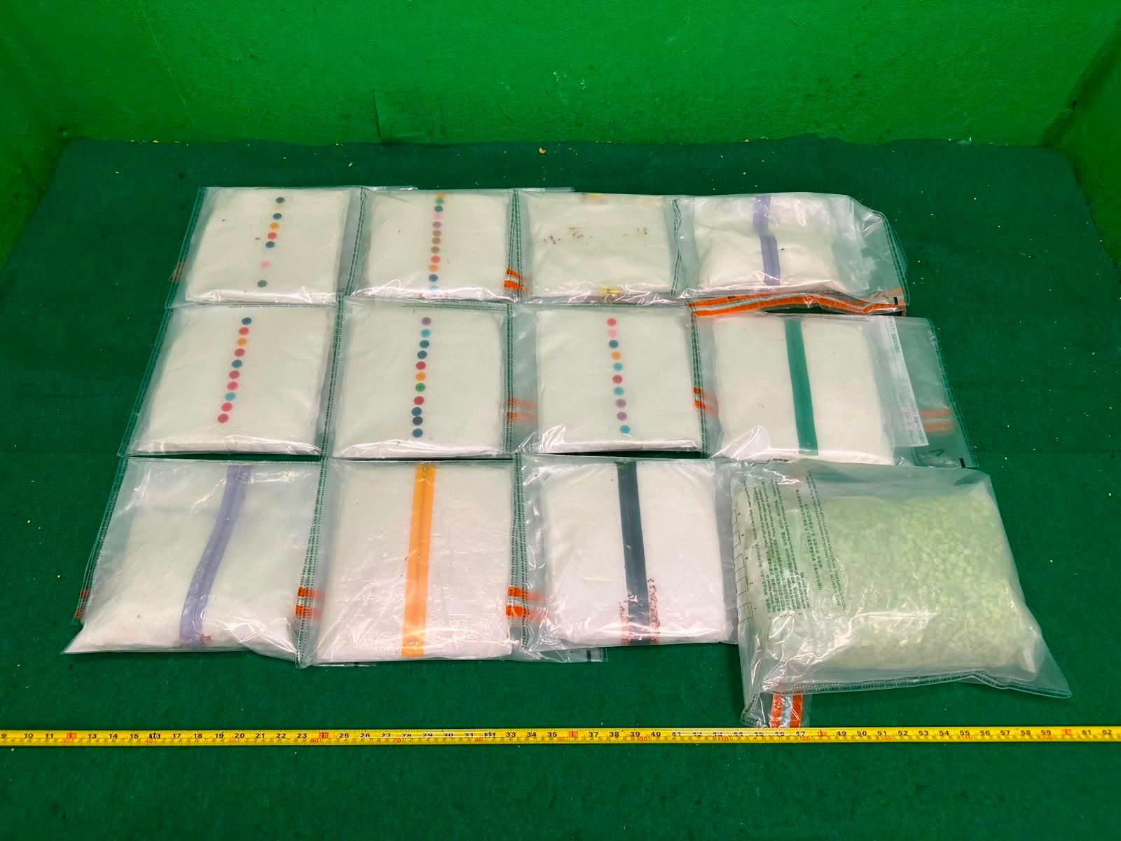 Hong Kong Customs detected a drug trafficking case involving two incoming passengers at Hong Kong International Airport yesterday (July 12) and seized about 28 kilograms of suspected ketamine, about 4kg of suspected MDMA, and two items of suspected alternative smoking products, with an estimated market value of about $11.8 million. Photo shows the suspected ketamine and suspected MDMA seized from the 22-year-old passenger.