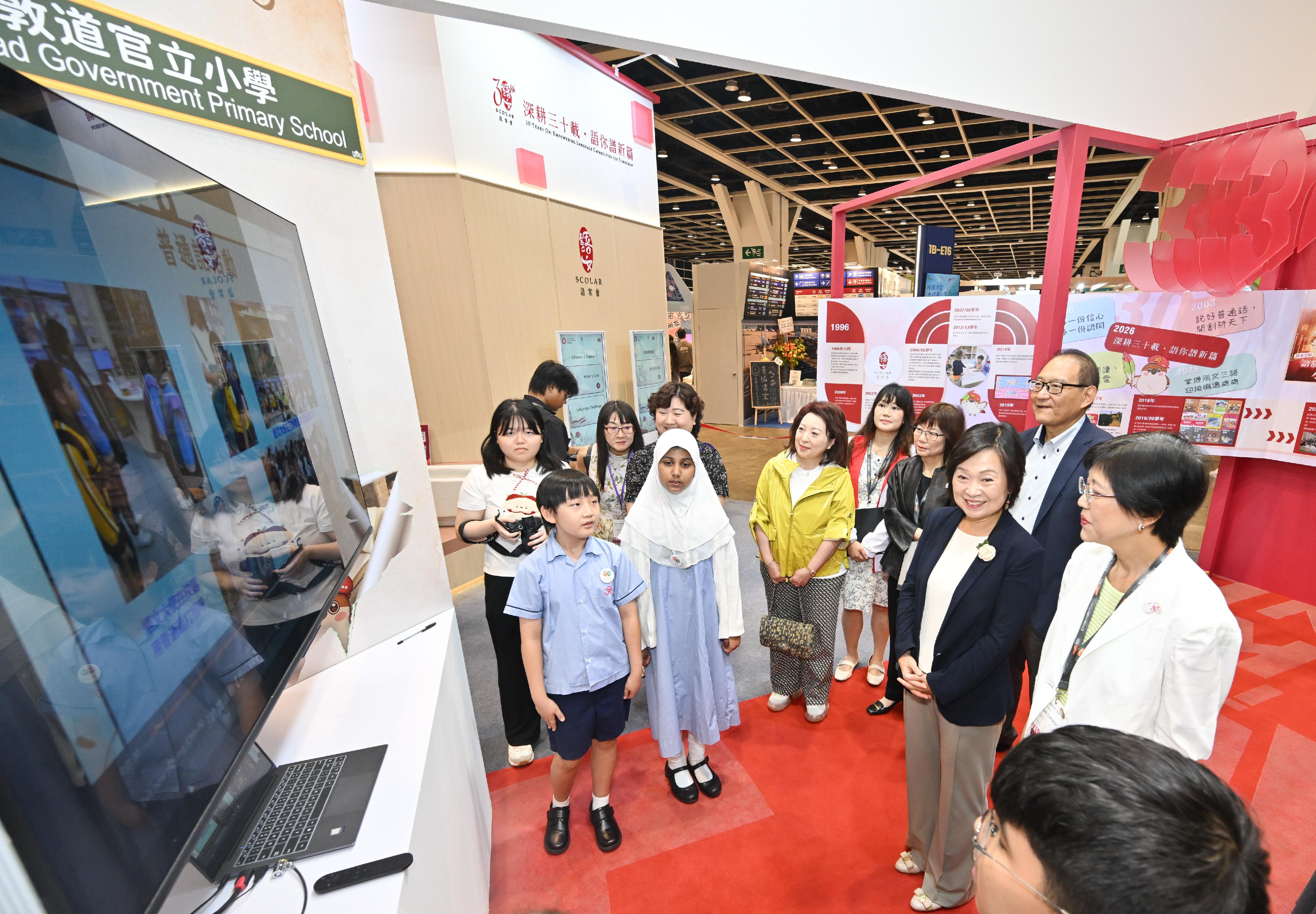 The Standing Committee on Language Education and Research (SCOLAR) has set up a booth themed "30th Anniversary of SCOLAR" at the 36th Hong Kong Book Fair held from July 15 to 21. Photo shows the Secretary for Education, Dr Choi Yuk-lin (front row, second right), and the Chairperson of SCOLAR, Dr Anissa Chan (front row, first right), interacting with the Student Language Ambassadors at the booth.