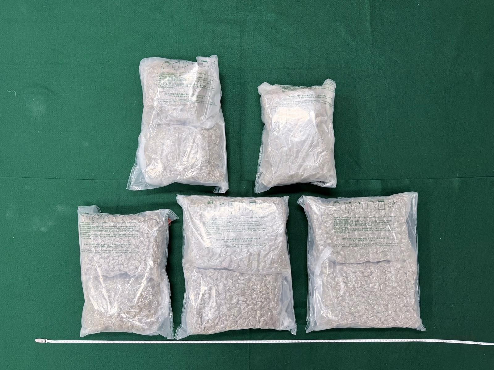 Hong Kong Customs yesterday (July 16) detected two drug trafficking cases involving air passengers at Hong Kong International Airport and seized about 21 kilograms of suspected cannabis buds with an estimated market value of about $3.9 million. Two men were arrested. Photo shows the batch of the suspected cannabis buds seized from the checked-in suitcase of the 50-year-old Chinese male passenger.