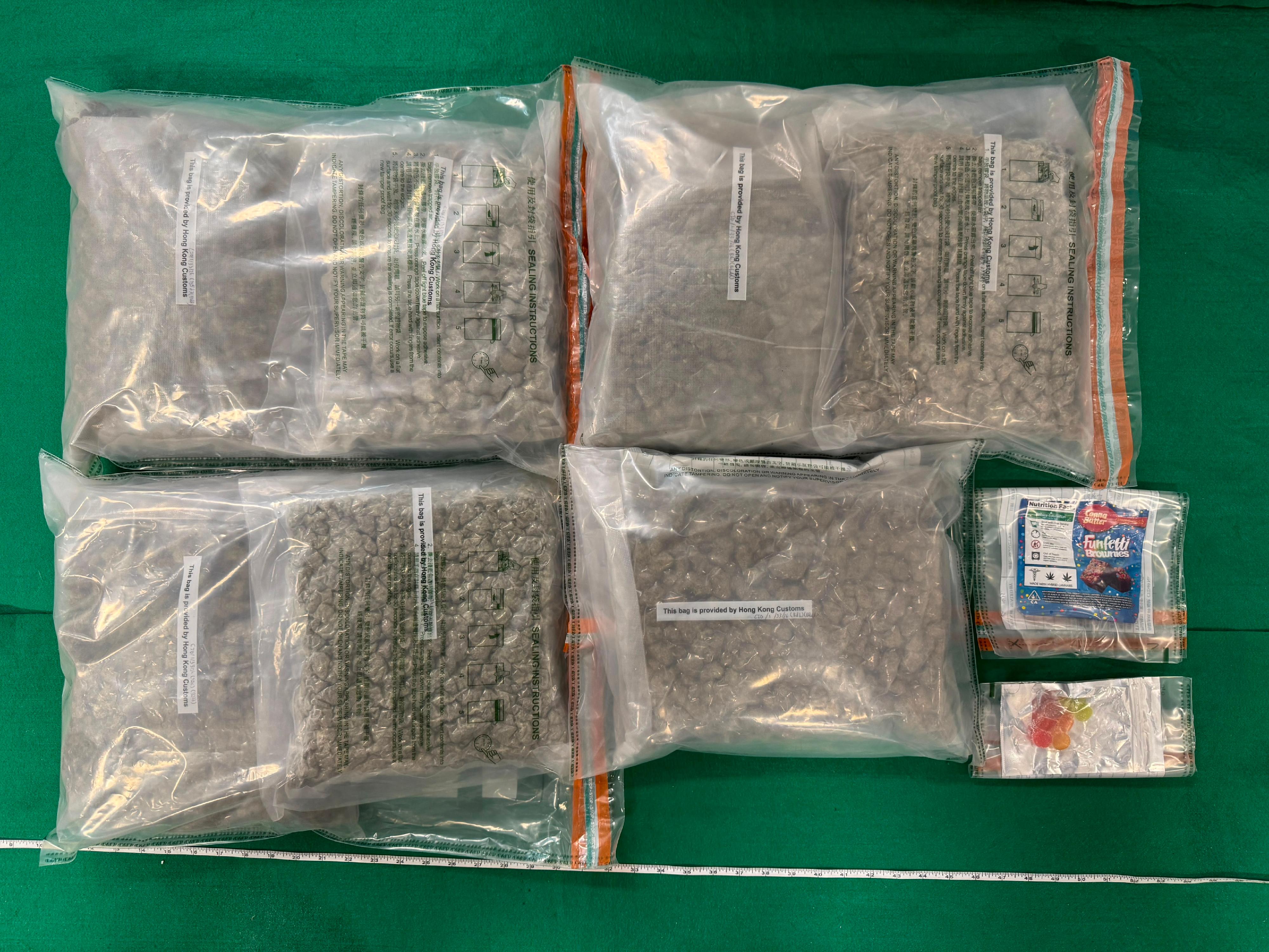 Hong Kong Customs yesterday (July 17) detected a drug trafficking case involving an incoming air passenger at Hong Kong International Airport and seized about seven kilograms of suspected cannabis buds, 40 grams of suspected cannabis biscuits and 20g of suspected cannabis gummy candies with an estimated market value of about $1.3 million. Photo shows the suspected cannabis buds and suspected cannabis products seized.